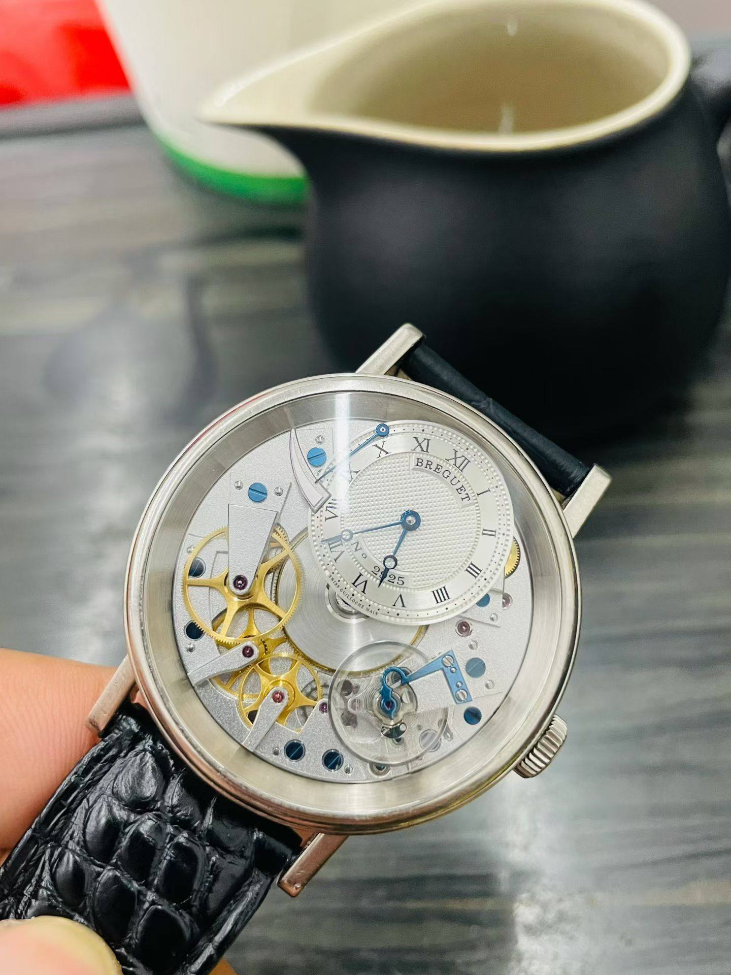 May be an image of wrist watch and text that says 'e XI BREG BREGUER XII XTI A IT 3 25 I III A Go df'