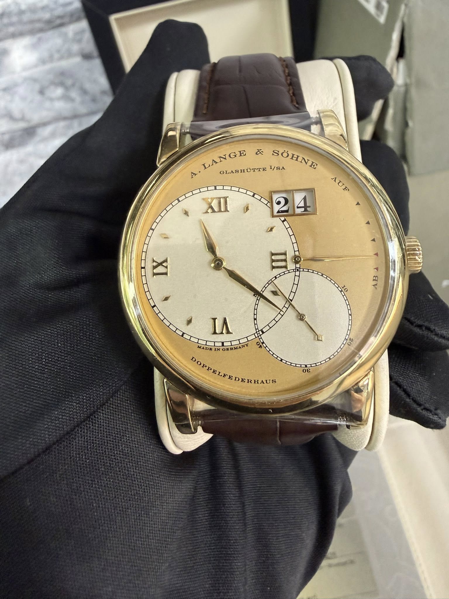 May be an image of wrist watch and text that says 'LANGE E & A OLABHÜTTE SOHNE 1/8A SÖHNE AUE XII 2 24 4 ပ IX BV LA MADE: O6ИMHT DOPPELEEDERHAUS CKHAUS 06'