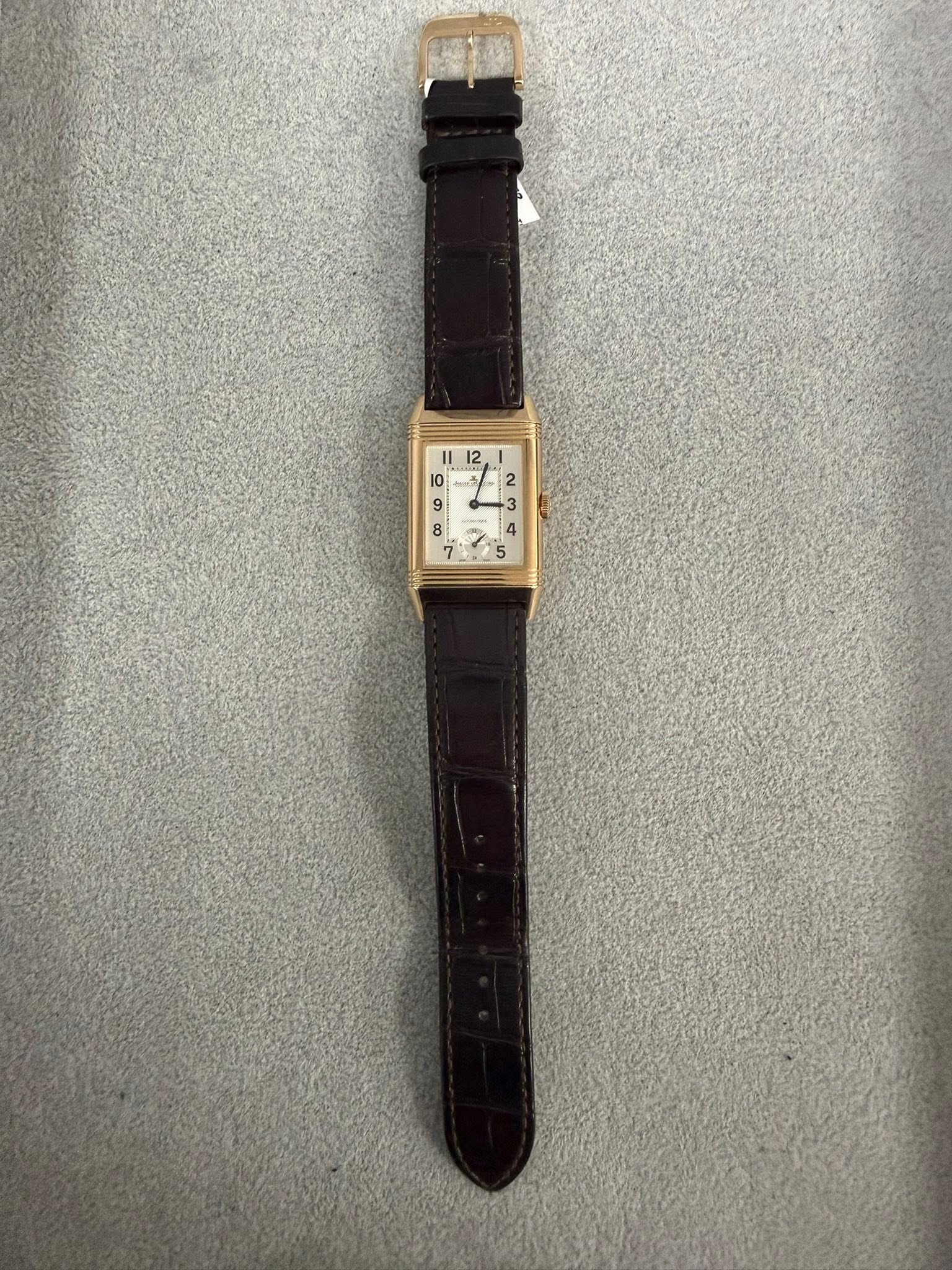 May be an image of wrist watch, leather and text