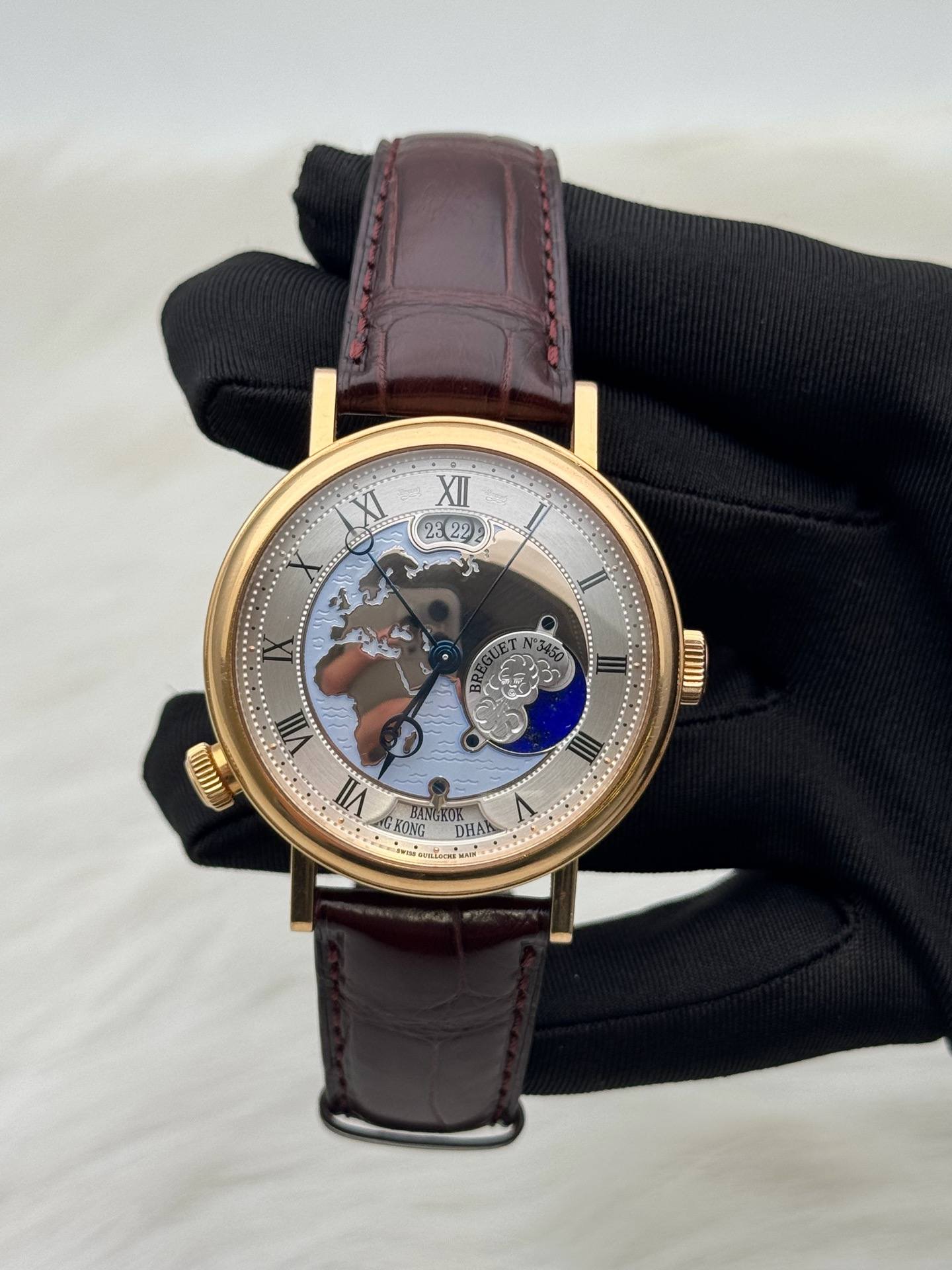May be an image of wrist watch and text that says 'XII 23 23 II سح T mim ስ I ማር KONG OA DHAA'