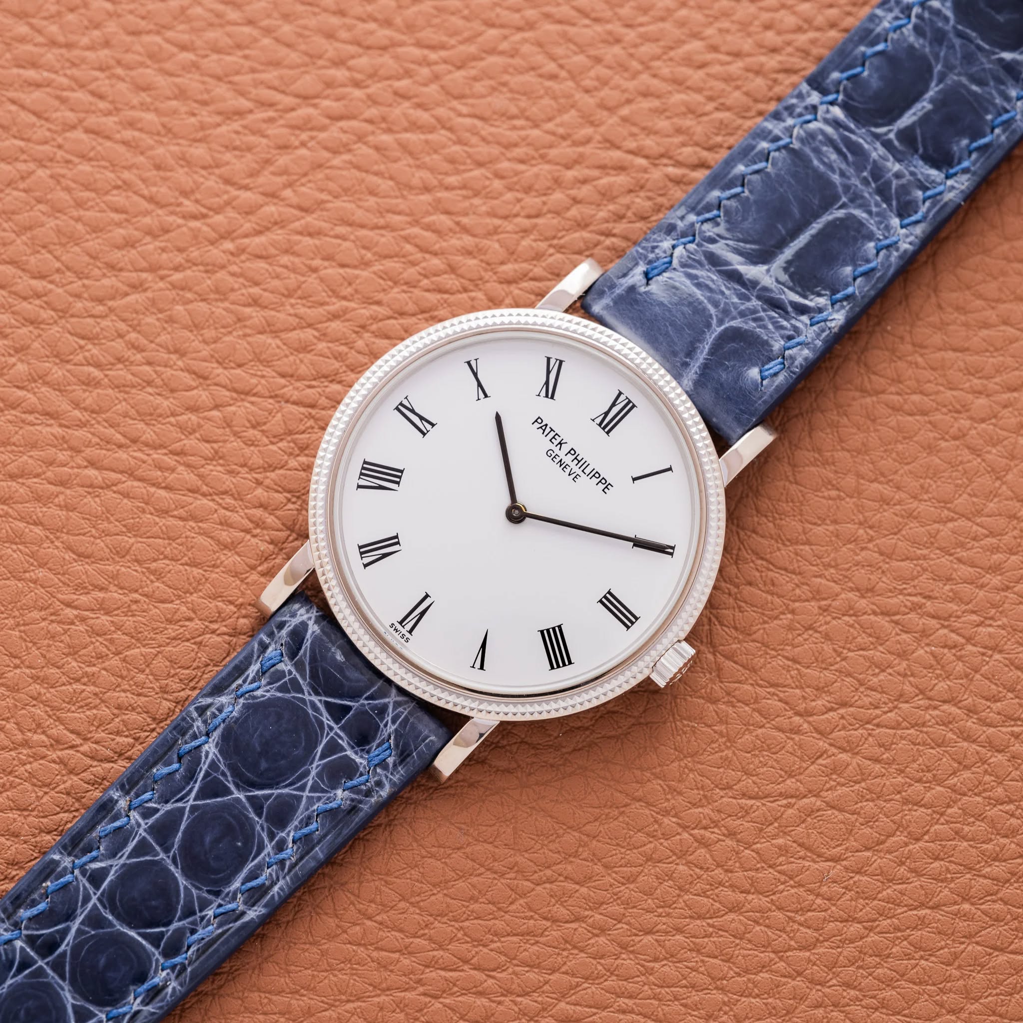 May be an image of wrist watch, leather and saddle-stitched leather
