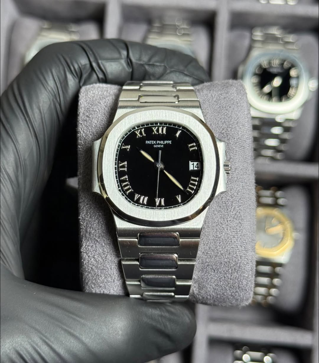 May be an image of wrist watch and text that says 'X. IU A PATEK PATEKPHILIPPE PPE GENE N TT i LT 2 IILA VAN VI ب > TIIT TIIT'