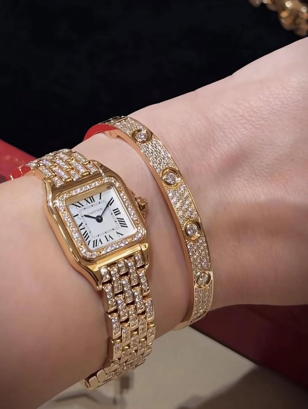 May be an image of jewelry, wrist watch and text