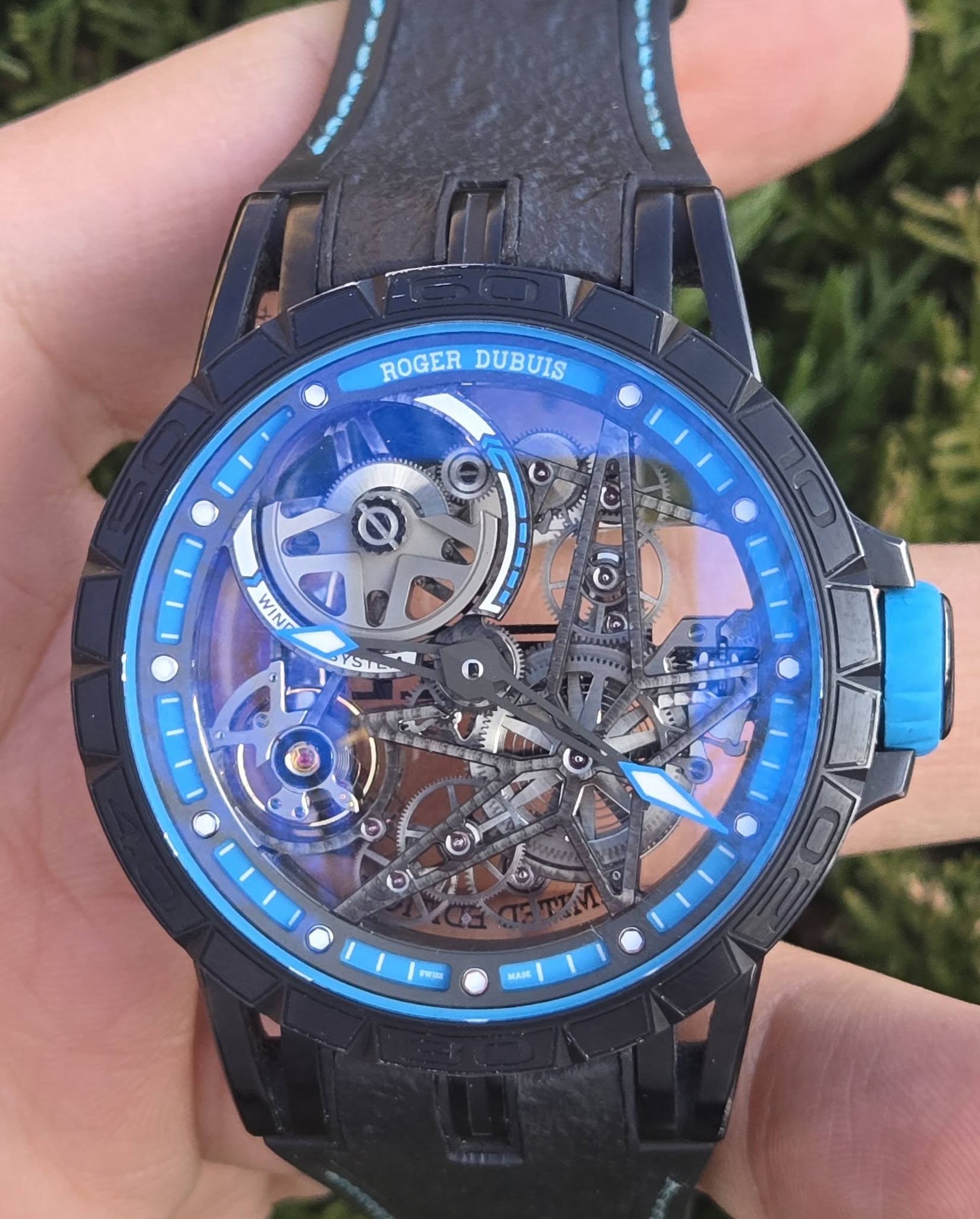 May be an image of digital watch and text that says 'ROGER_DUBUIS ROGER DUBUIS ២ 00 WIN WI O கன YSTS G E فش. မ မ 0 Peras MASE'