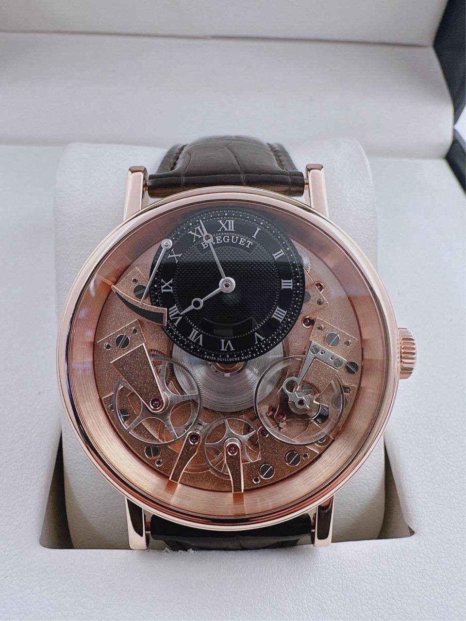 May be an image of wrist watch and text that says '9 XII LEGUET REGUET I n I III R'