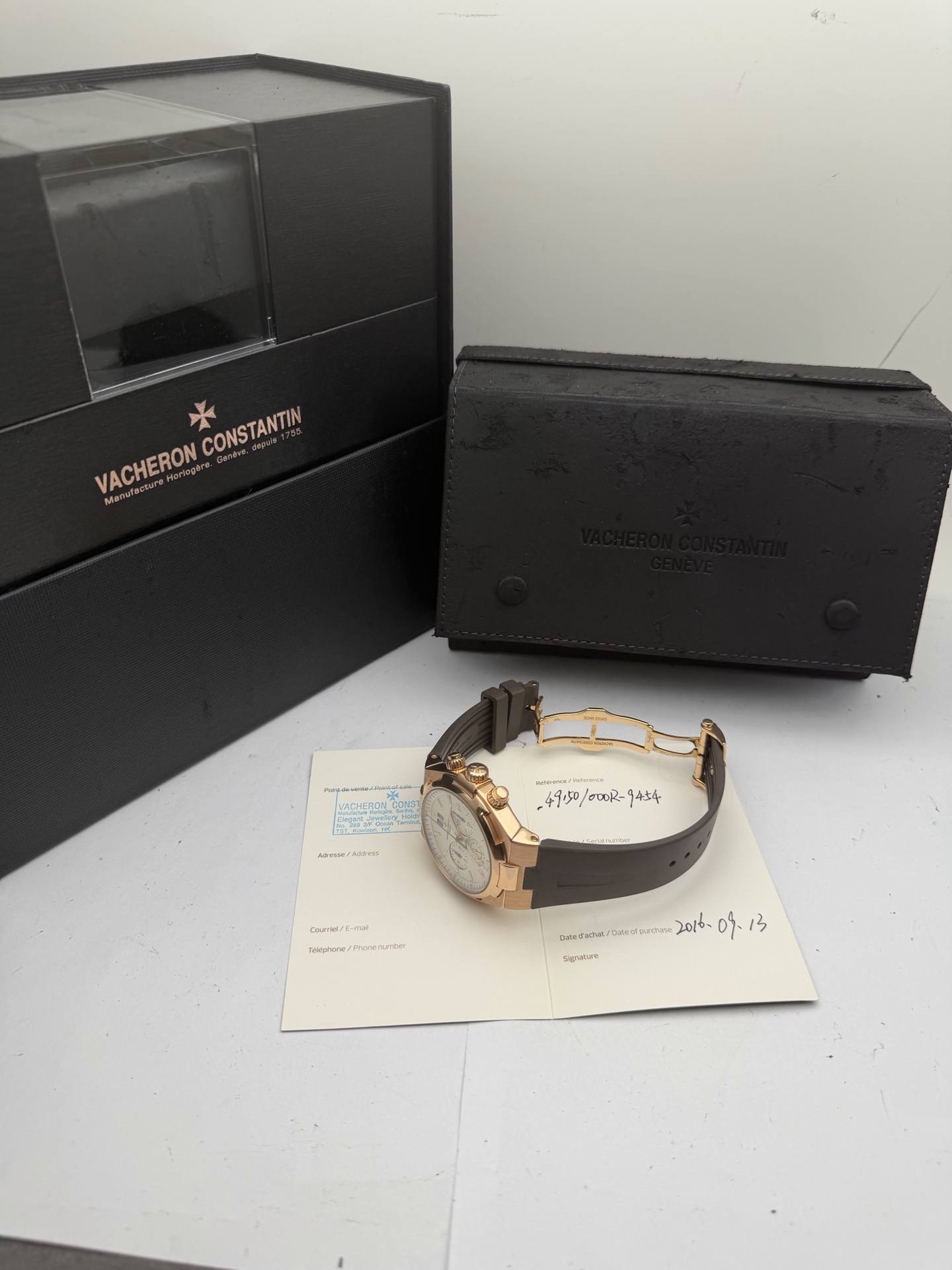 May be an image of leather, leather wallet, wrist watch and text