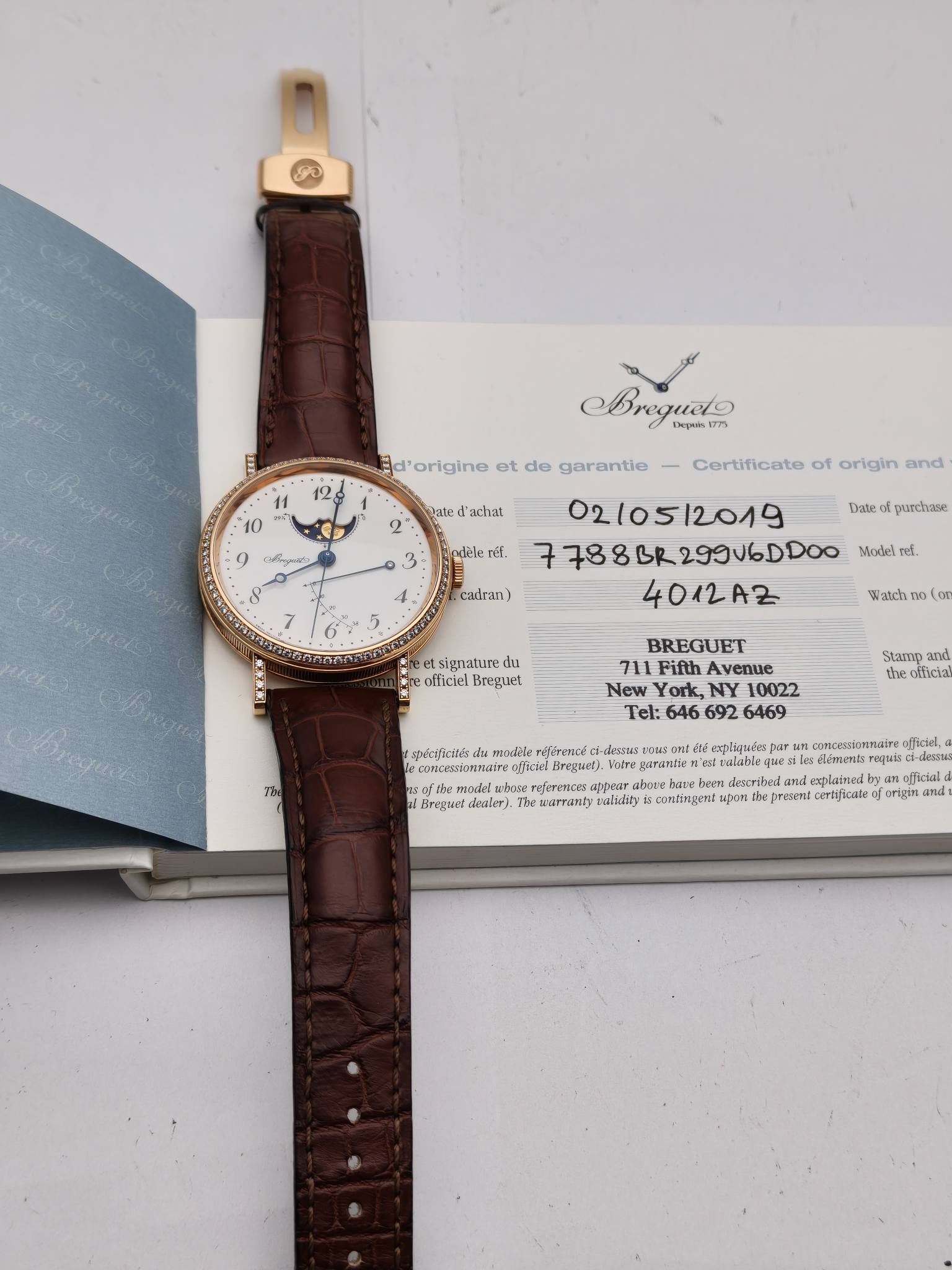 May be an image of leather, wrist watch and text