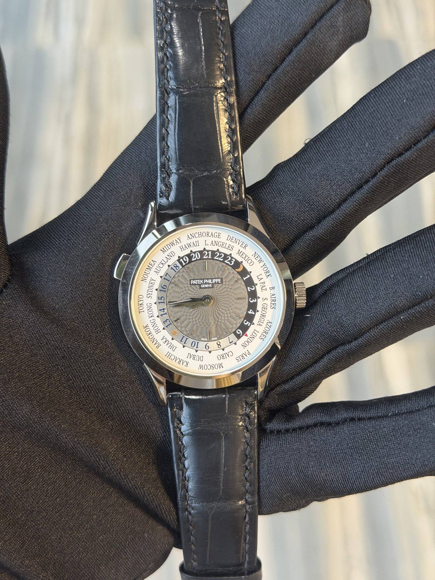 May be an image of leather, wrist watch and text