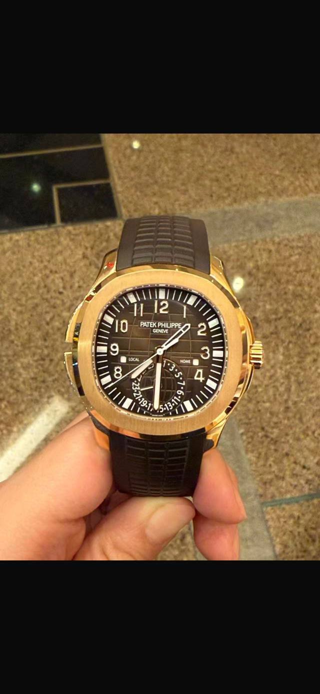 May be an image of wrist watch and text that says '12 11 O PATEK PHILPPE GENEVE E Y 9 9C 8 P 2 HOME 3 ዛበ! - e 1-19- قر ደ'