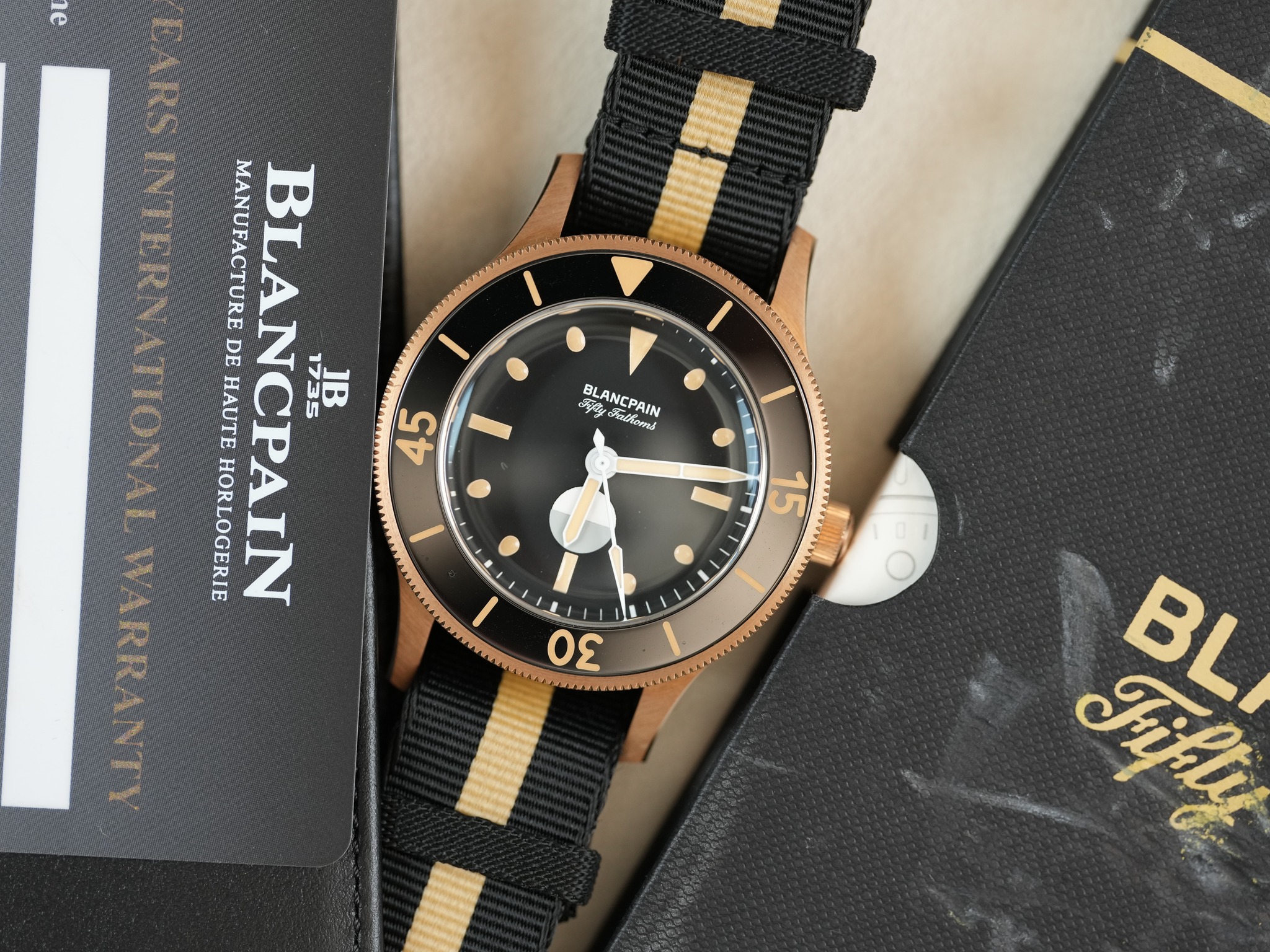 May be an image of wrist watch and text that says '٣ I y กิอยนอรงี BLANCPAIN MANUFACTURE BLA HAUTE DE BLANCPAIN NCPA 45 HORLOGERIE NCPAIN 1735 JB 15 KO I 30 Fikty BL'