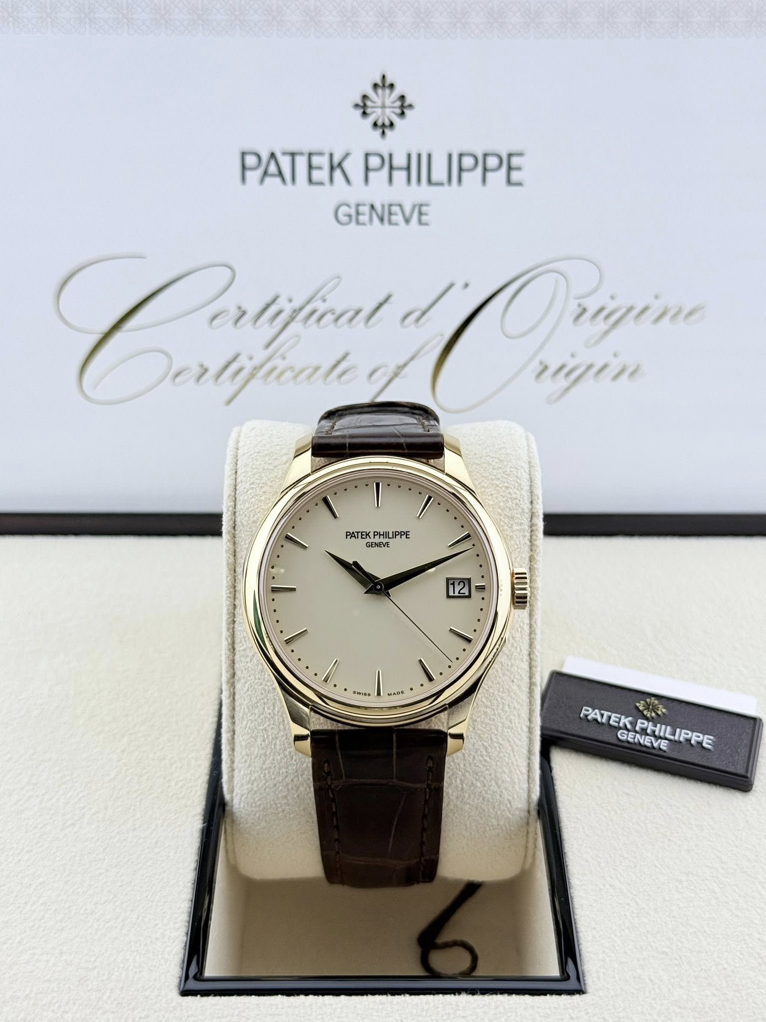 May be an image of wrist watch and text that says 'PATEK PATEKPHILIPPE PHILIPPE GENEVE Caatfiut lificale Portifical Derlificale Orizina rigin PATEKP DNEVE PHILIPPE GENEVE 12 1.…