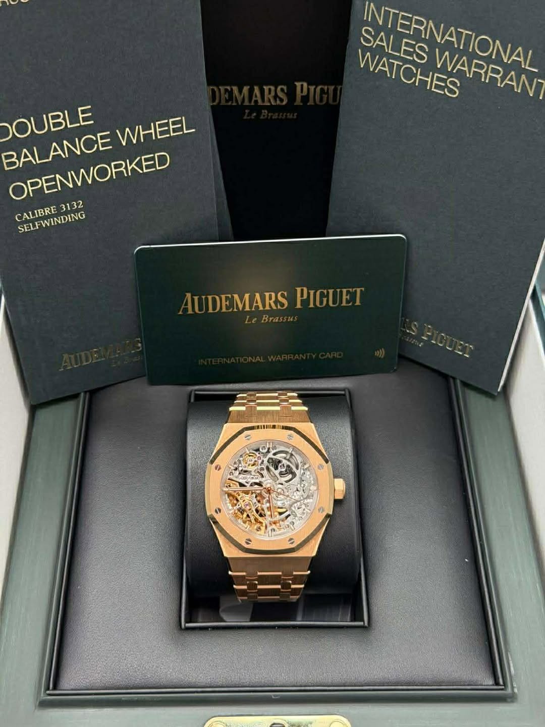 May be an image of wrist watch and text that says 'SALES WATCHES SATERNATIONAL WARRAN WATCHES DOUBLE WHEEL BALANCE OPENWORKED OPENWORKED CALIBRE 3132 SELFWINDING AUDEMARSPIGUET…