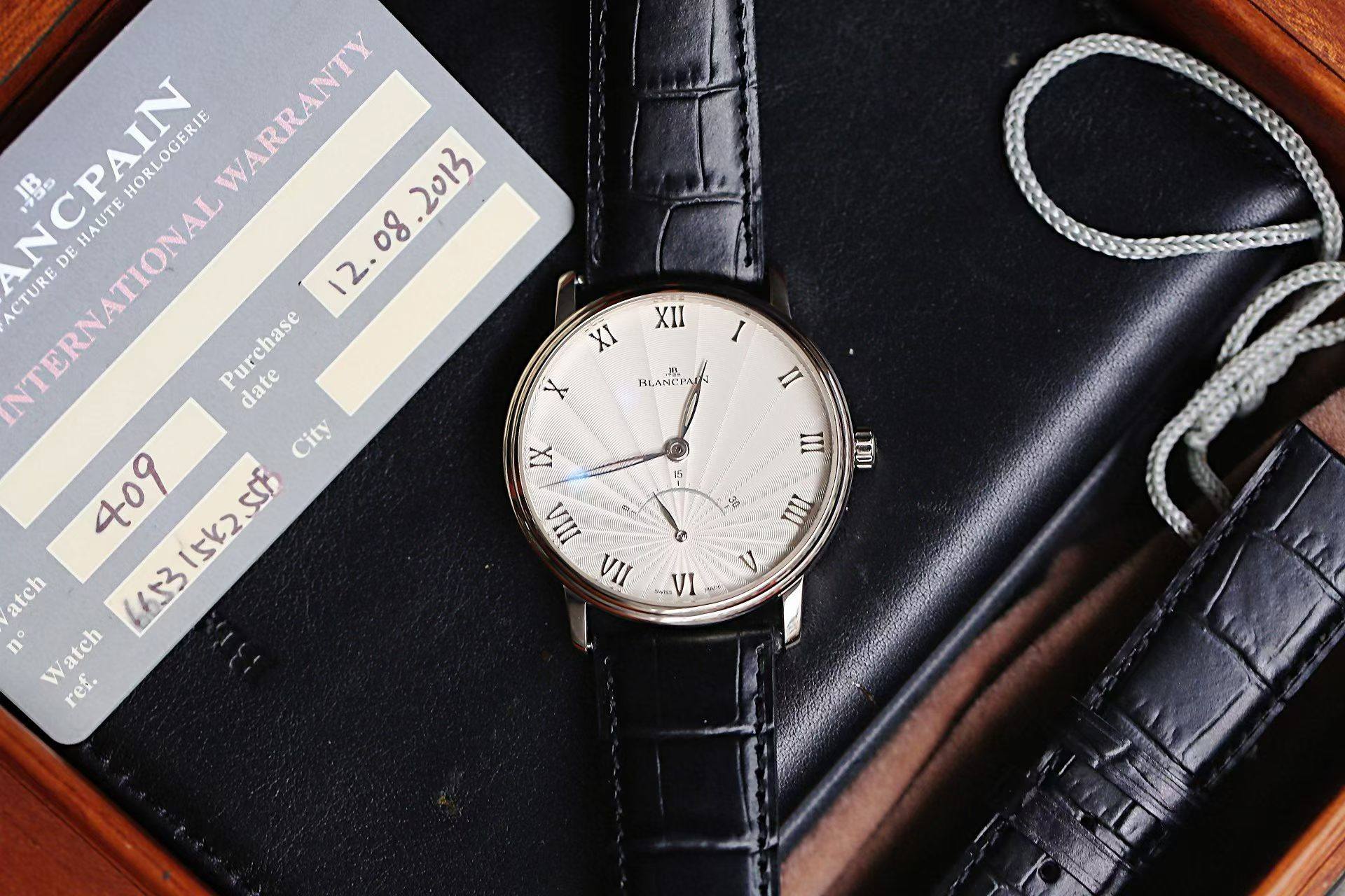 May be an image of wrist watch and text that says 'XII I ANCPAIN INTERNATIONAL IN AIN HORLOGERIE WARRANTY 2013 INTERNATIONA HAUTE ACTURE DE Purchase date City 409 15K2556 SSf 151ん…