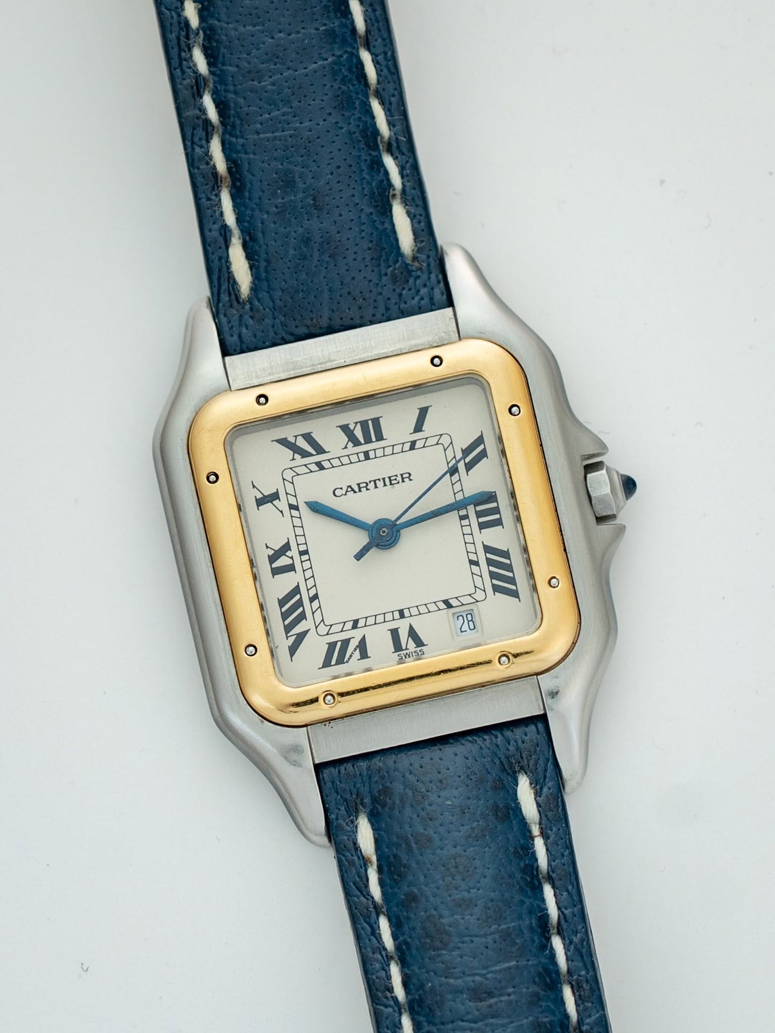 May be an image of leather, wrist watch and text