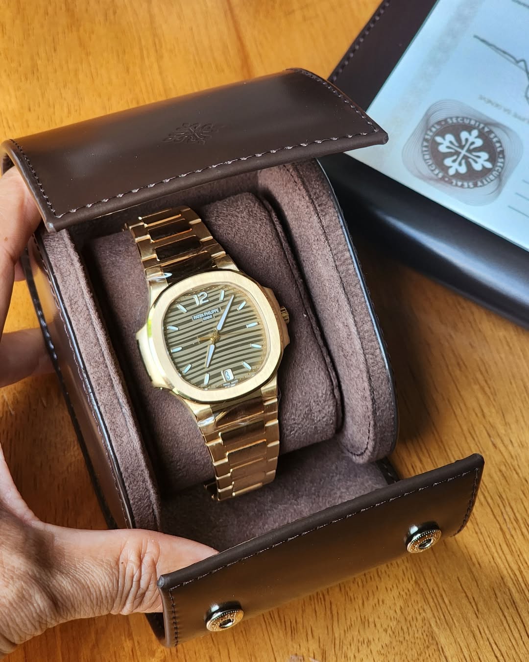 May be an image of saddle-stitched leather, wrist watch and text
