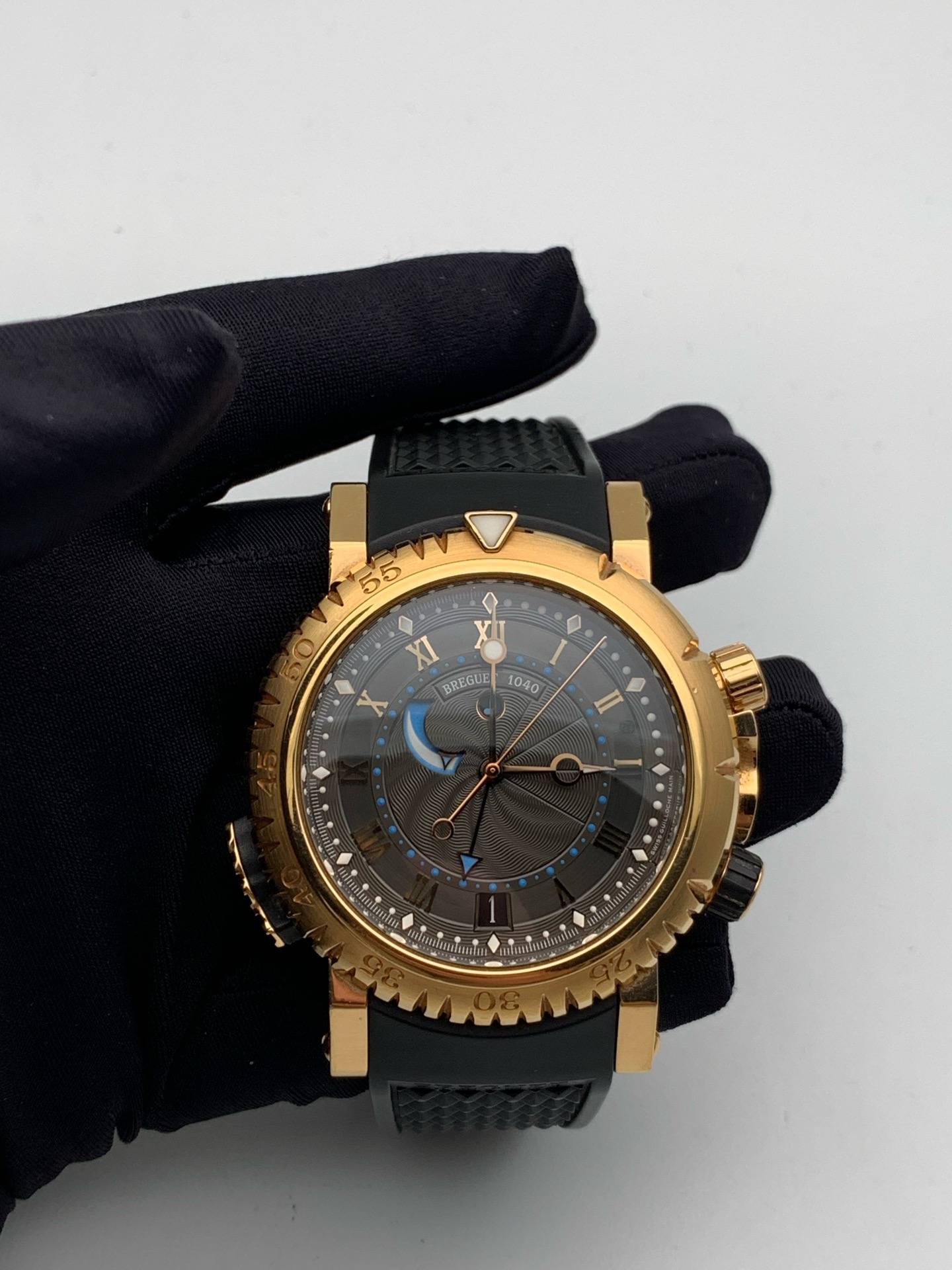 May be an image of wrist watch and text that says '55 XI X A BREGUE 1040 n I'