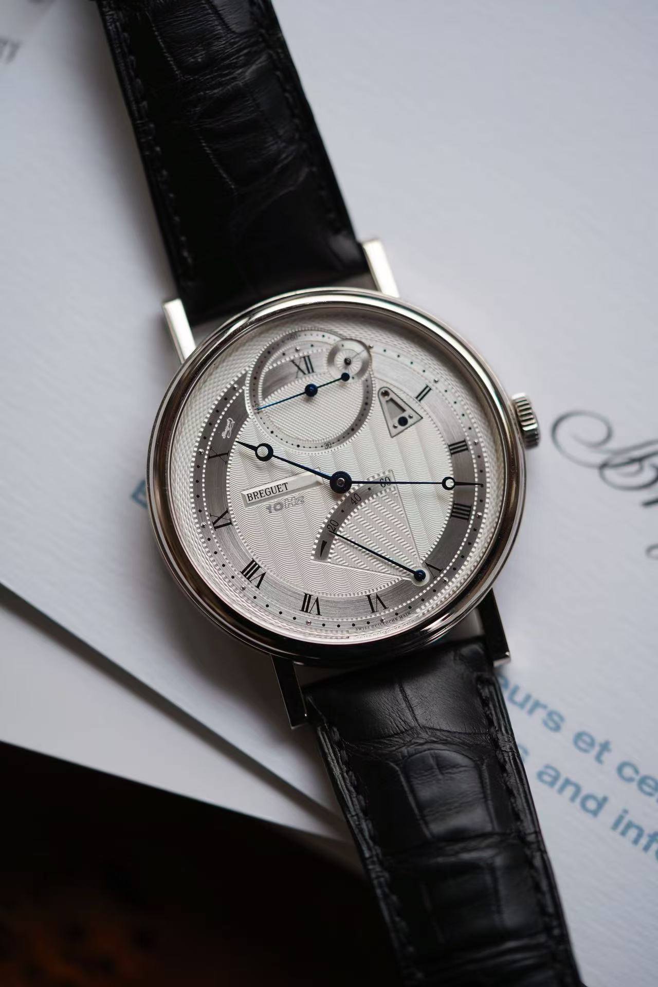 May be an image of wrist watch and text that says 'BREGUET VII UA ١٨ urs urs et ce ce and int'