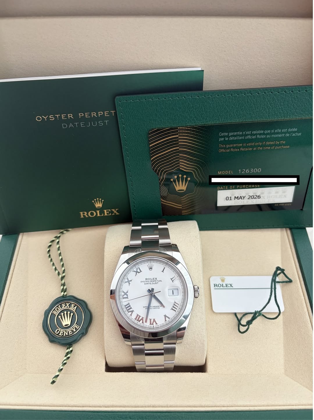 May be an image of wrist watch and text that says 'OYSTER OYSTERPERPE PERPE ATEJUST yifdstadyt MDDEL126300 MODEL 26300 ROLE 01 MAY 2026 PoLnX KOи XI BOL ROLEX STERPIUFETL EJUST…