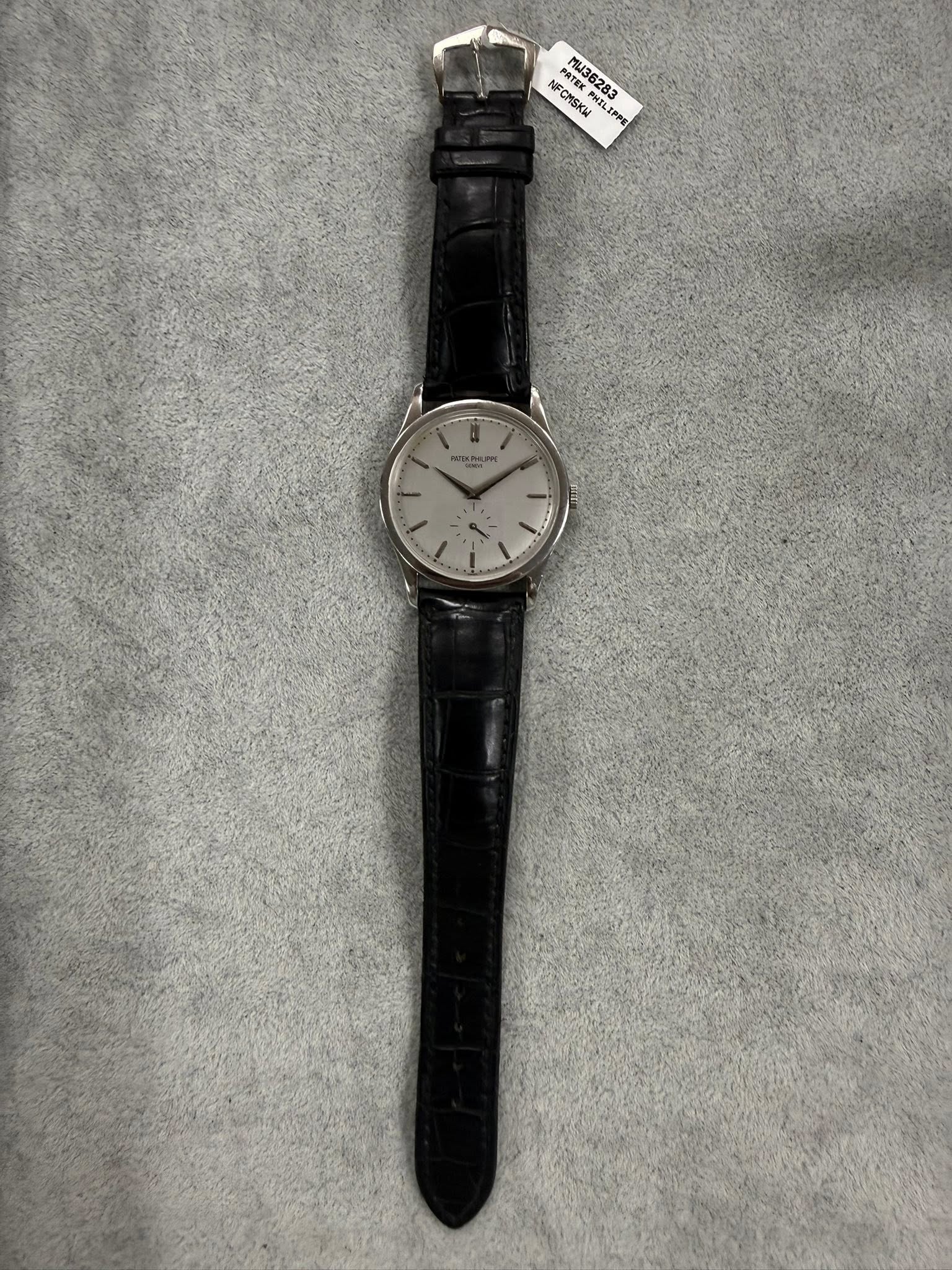 May be an image of leather, wrist watch and text