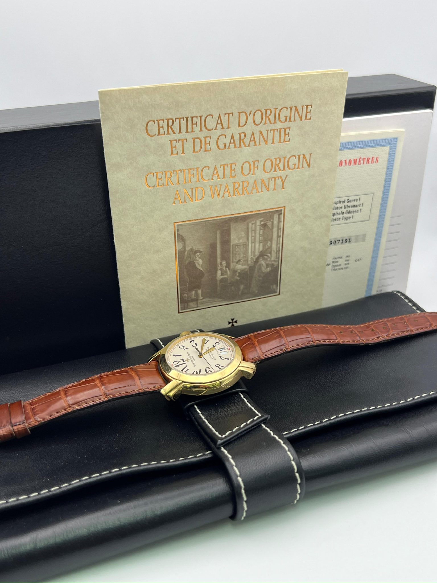 May be an image of wrist watch and text that says 'CERTIFICAT GARANTIE D'ORIGINE ET DE CERTIFICATE CERTIFICATEOFORIGIN OF ORIGIN AND WARRANTY OYOMÉTRES الهن Goore! ee Cleart…