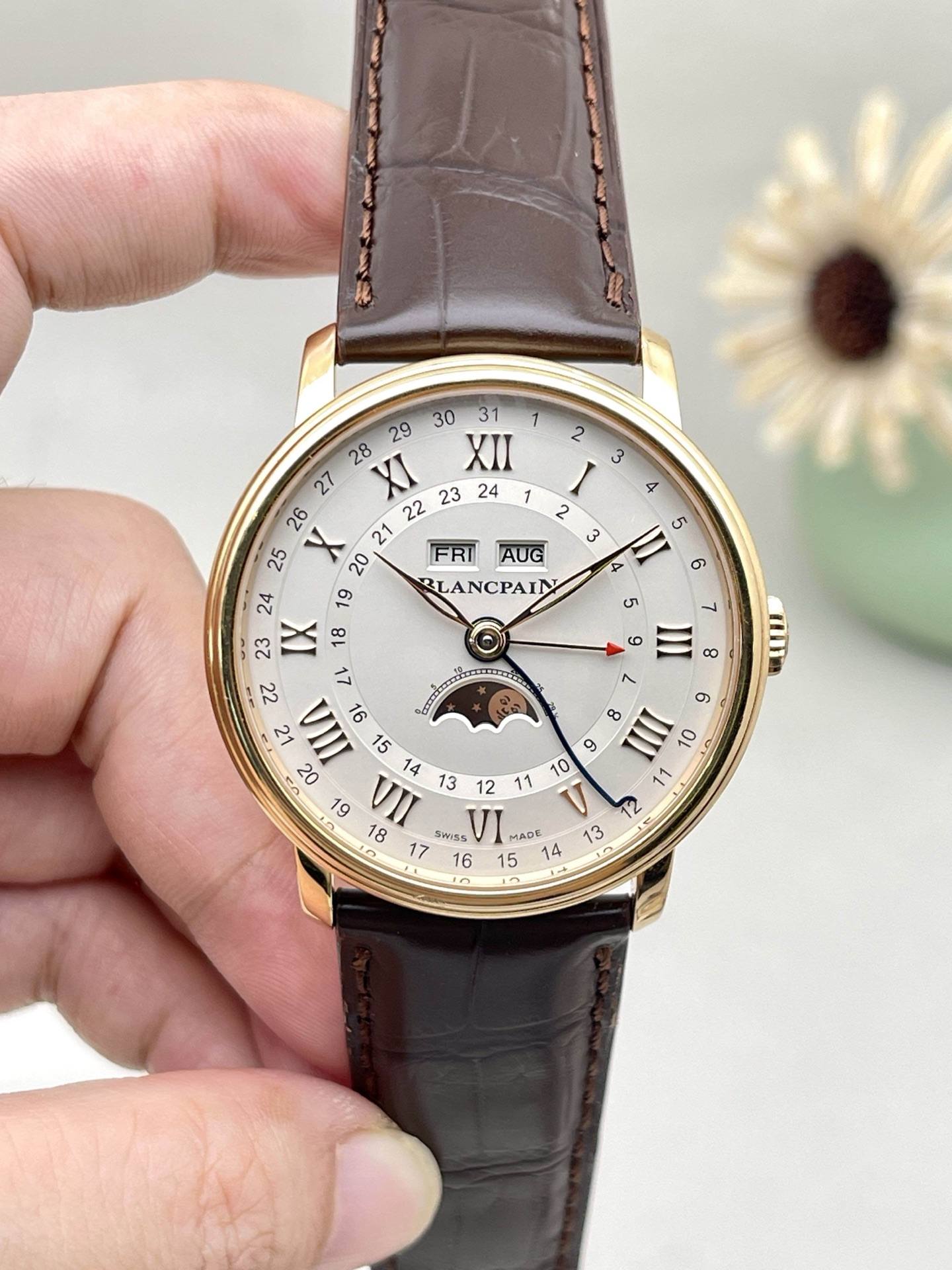 May be an image of wrist watch and text that says ' FRI AUG BL BLANCPAIN రా ဟ XI XII IX 18 レ VII L0 17 SmsS VI ADE B '