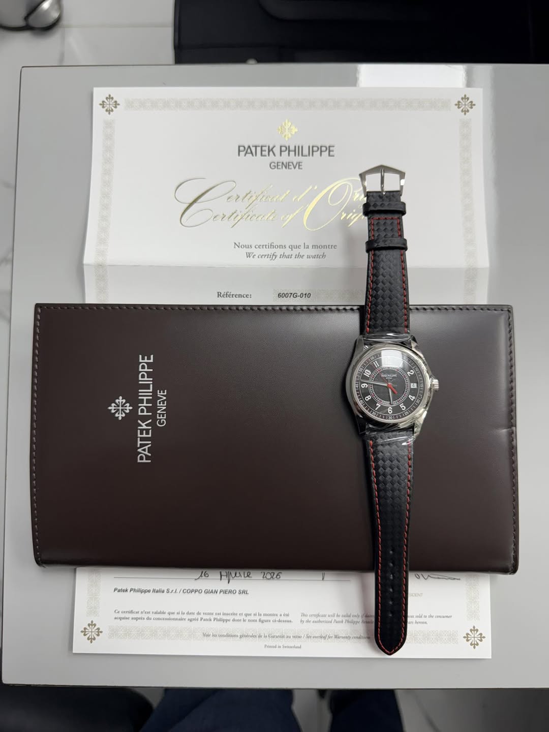 May be an image of saddle-stitched leather, wrist watch, leather and text