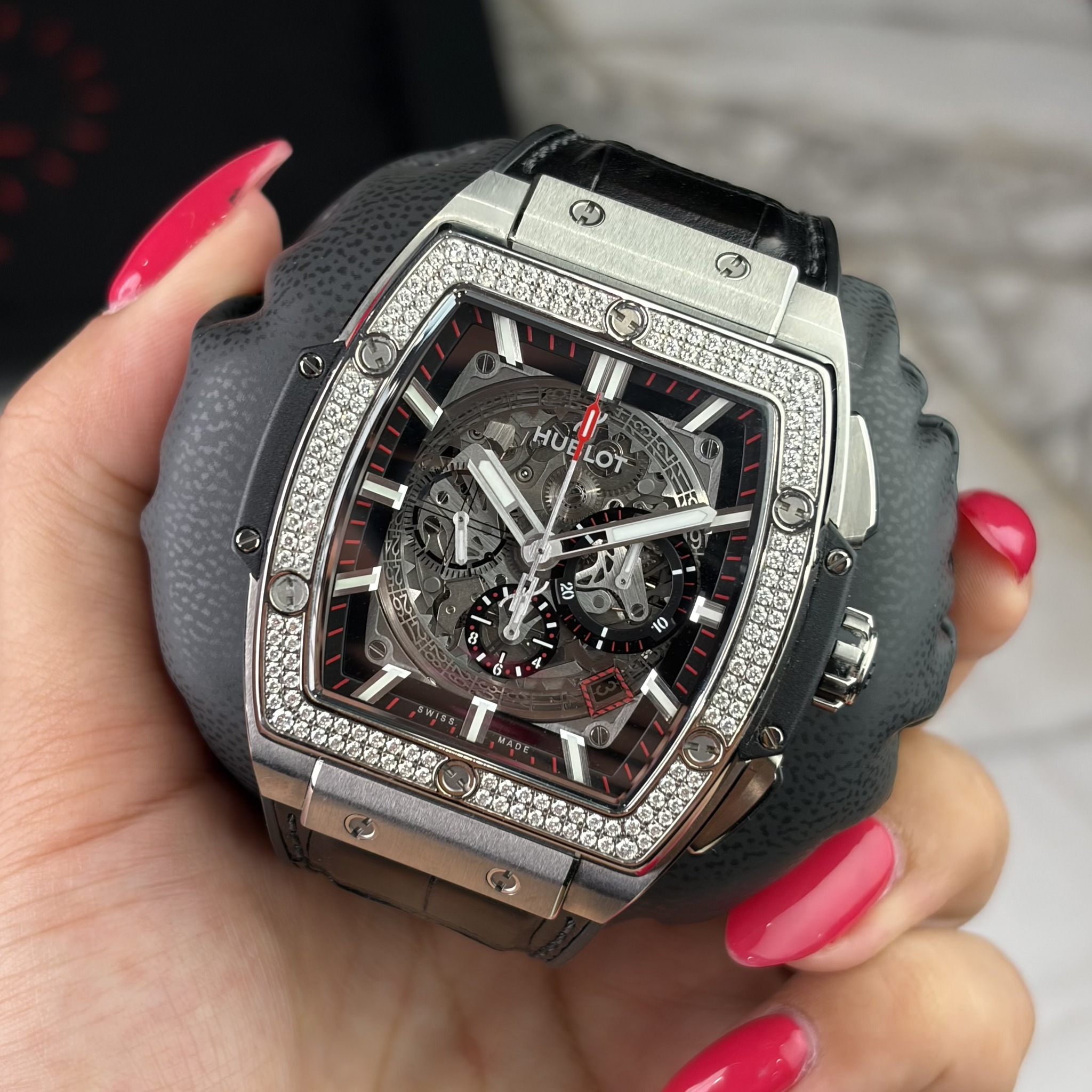 May be an image of wrist watch, strap, timer and text