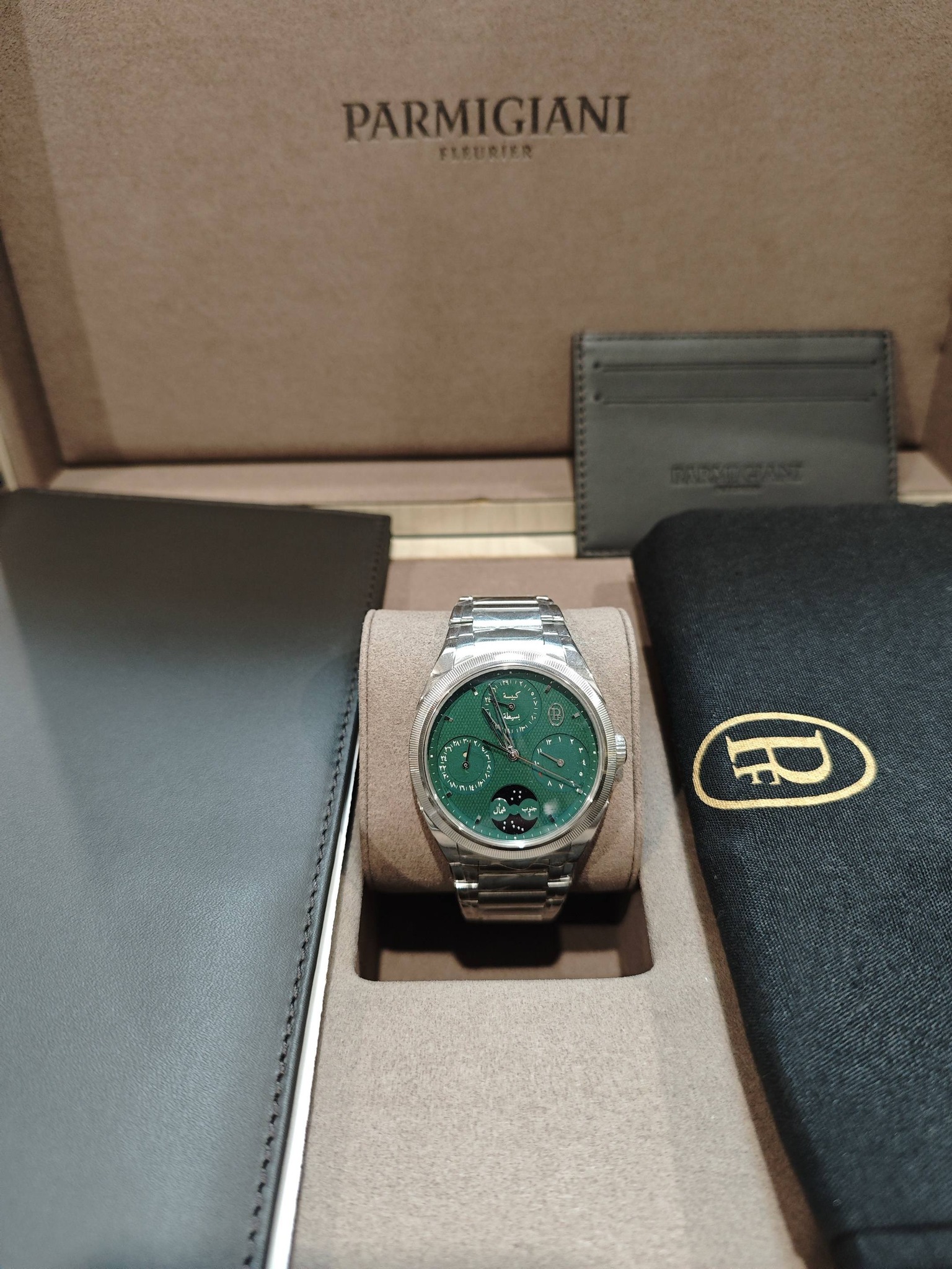 May be an image of wrist watch and text that says 'PARMIGIANI'