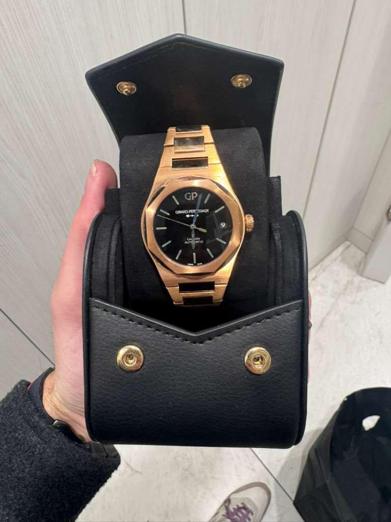 May be an image of wrist watch and text that says 'P GRARD-PE OACIK و'