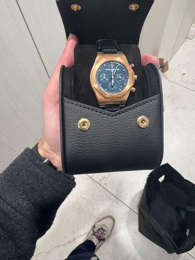 May be an image of leather wallet and wrist watch