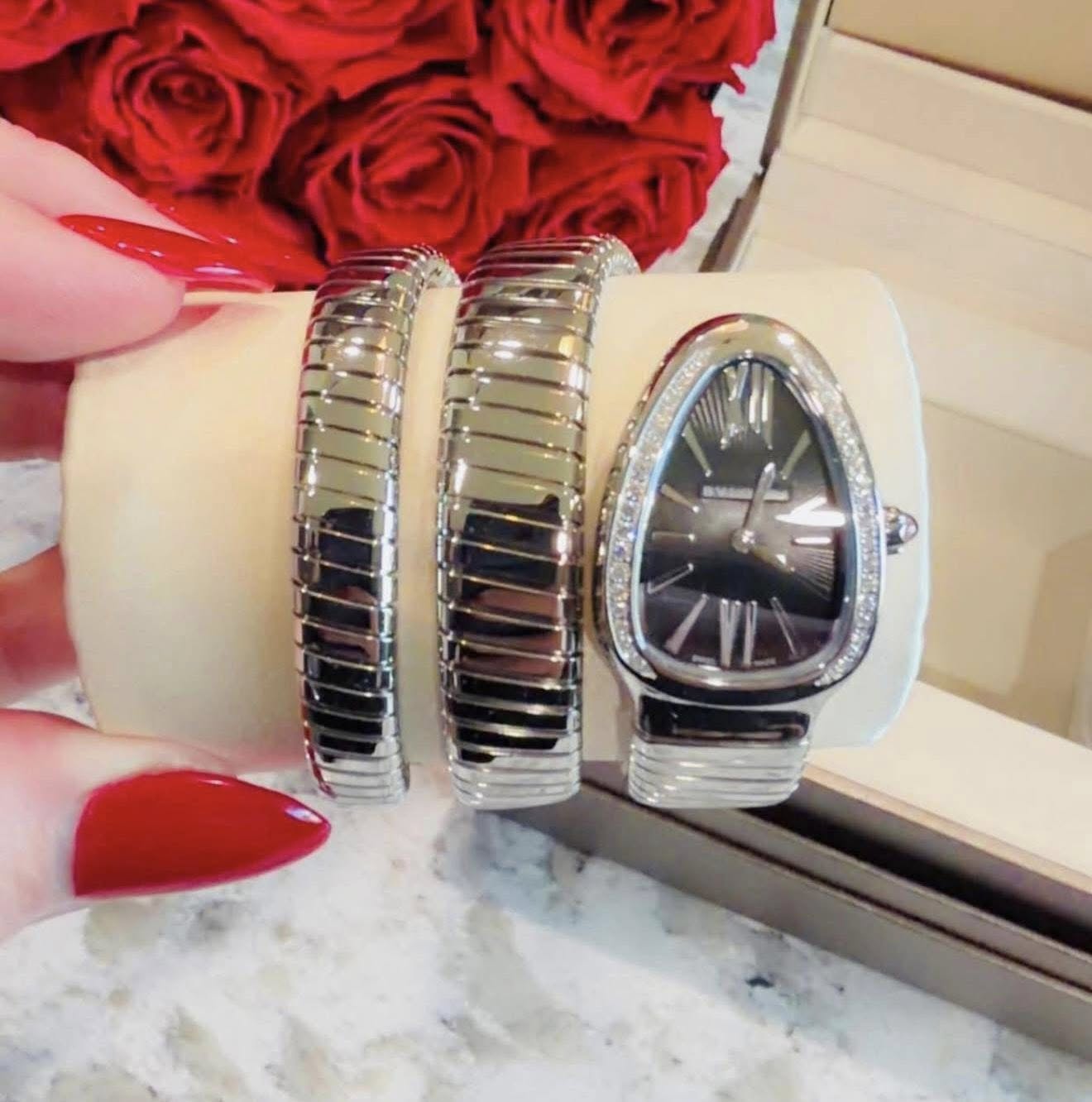 May be an image of wrist watch and jewelry