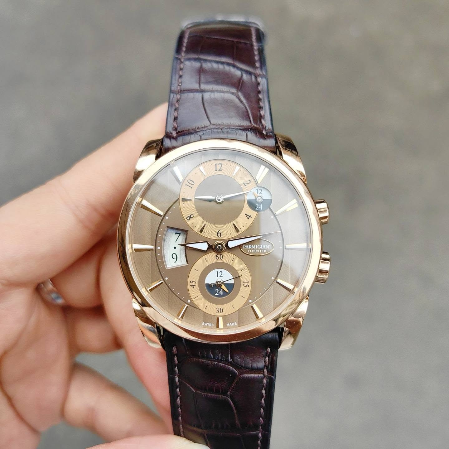 May be an image of wrist watch and text that says '12 12 10 A ॐ 2 12 24 ኢ ၀ 6 o O 0 9 PARMIGIAN 12 2 45 ST 24 E 30 F6155 บม'