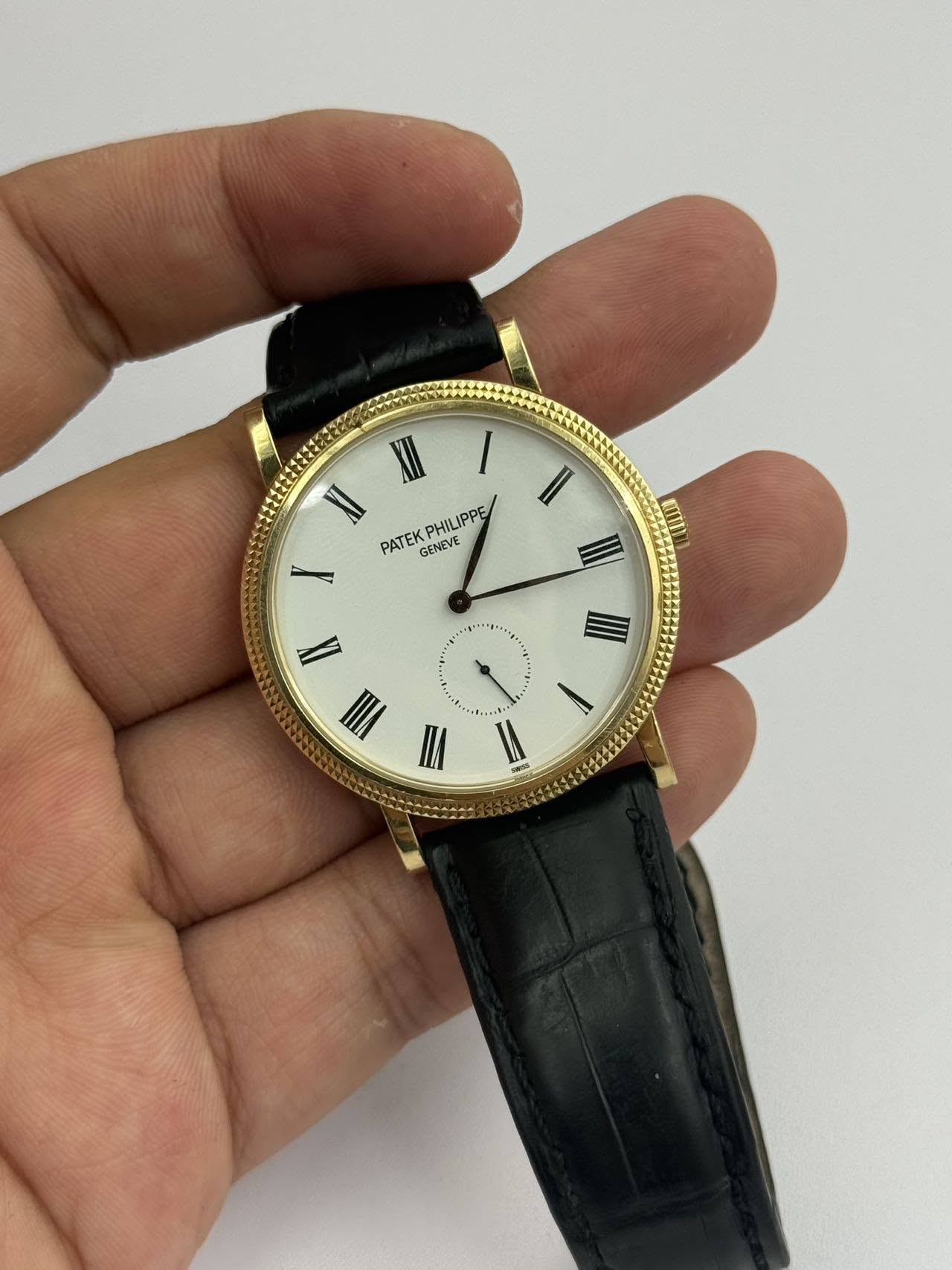 May be an image of wrist watch and text that says 'I XI PHILIPPE PATEK GENEVE II VII VI I 一'