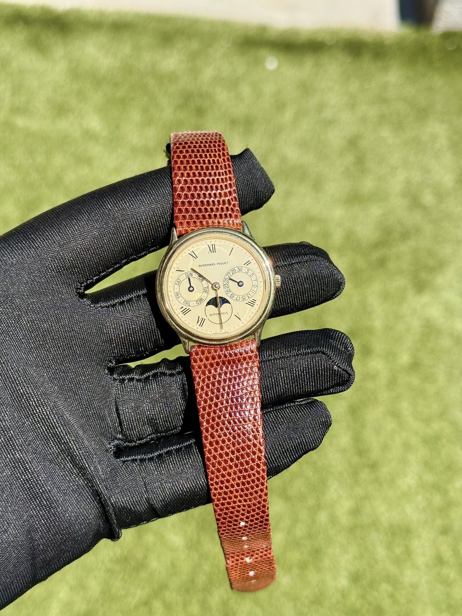 May be an image of leather, wrist watch and text