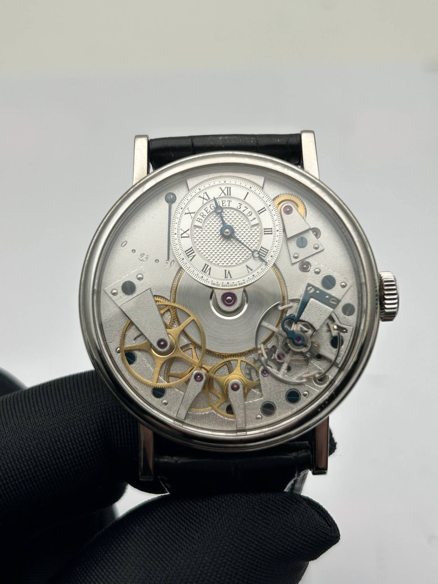 May be an image of wrist watch and text that says 'XI XII ናት RE EG ET 79 0 ٥ III III VII L 1 LA'