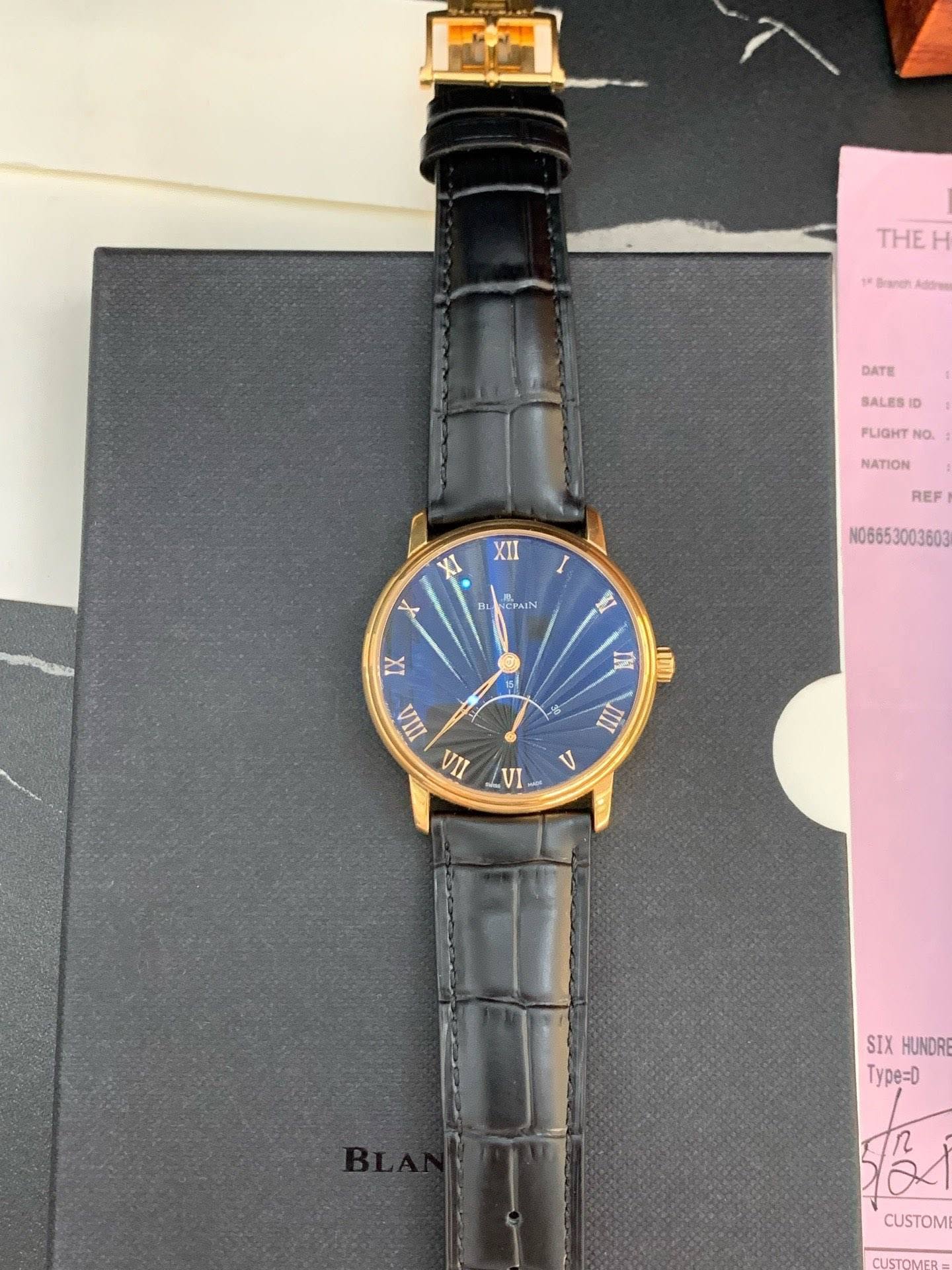 May be an image of wrist watch and text that says 'THEH THE Branen Addrge DATE SALES FLIGHT NO. XII XI NATION REF ISL หป NCPAIN X N0665 N06653003603 धा IX 1 5 IN IIII A A VI V SIX…