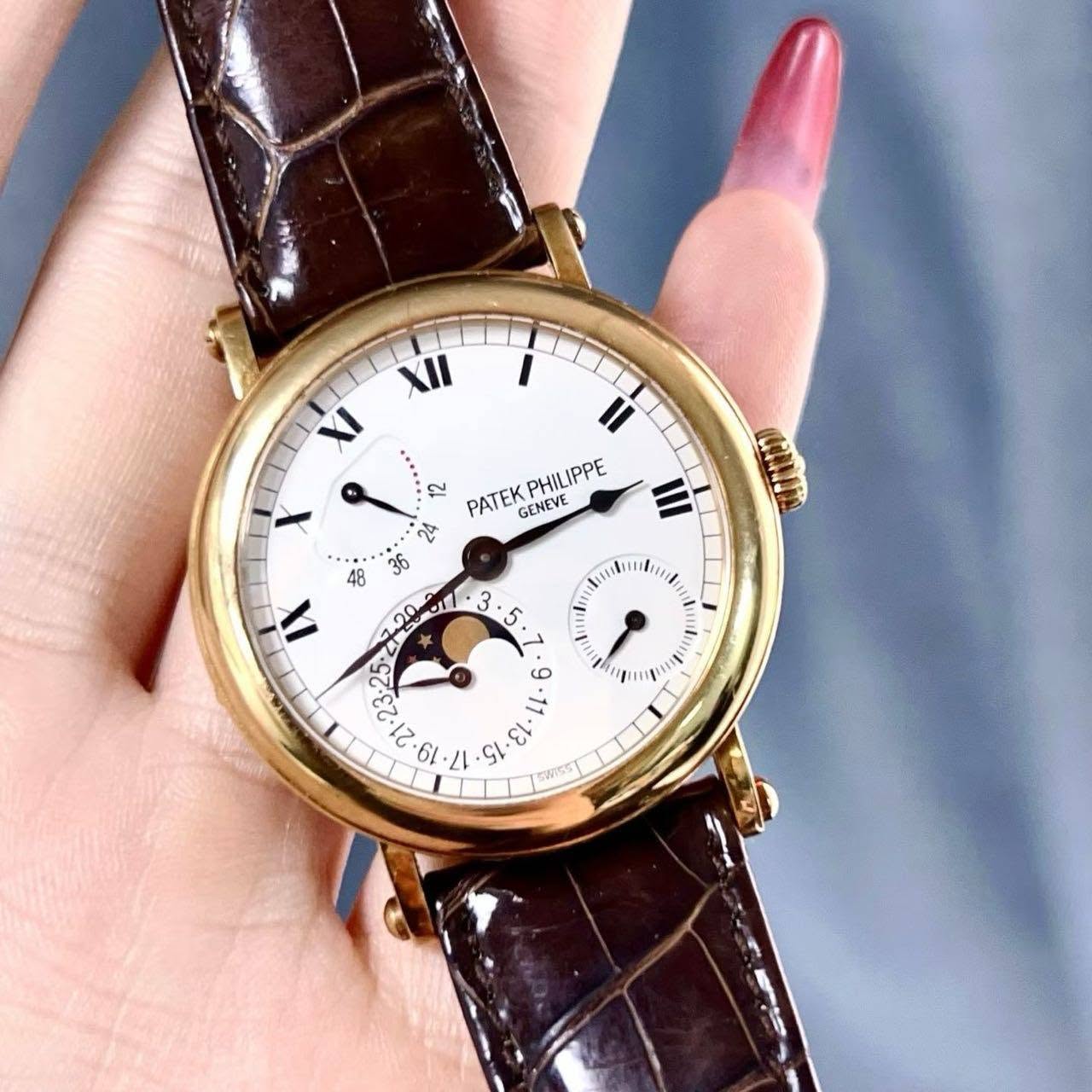 May be an image of wrist watch and text that says 'XII XI X 48 X 12 PATEK GENEVE PHILIPPE 2्म fo :25° El CL Snss و W'