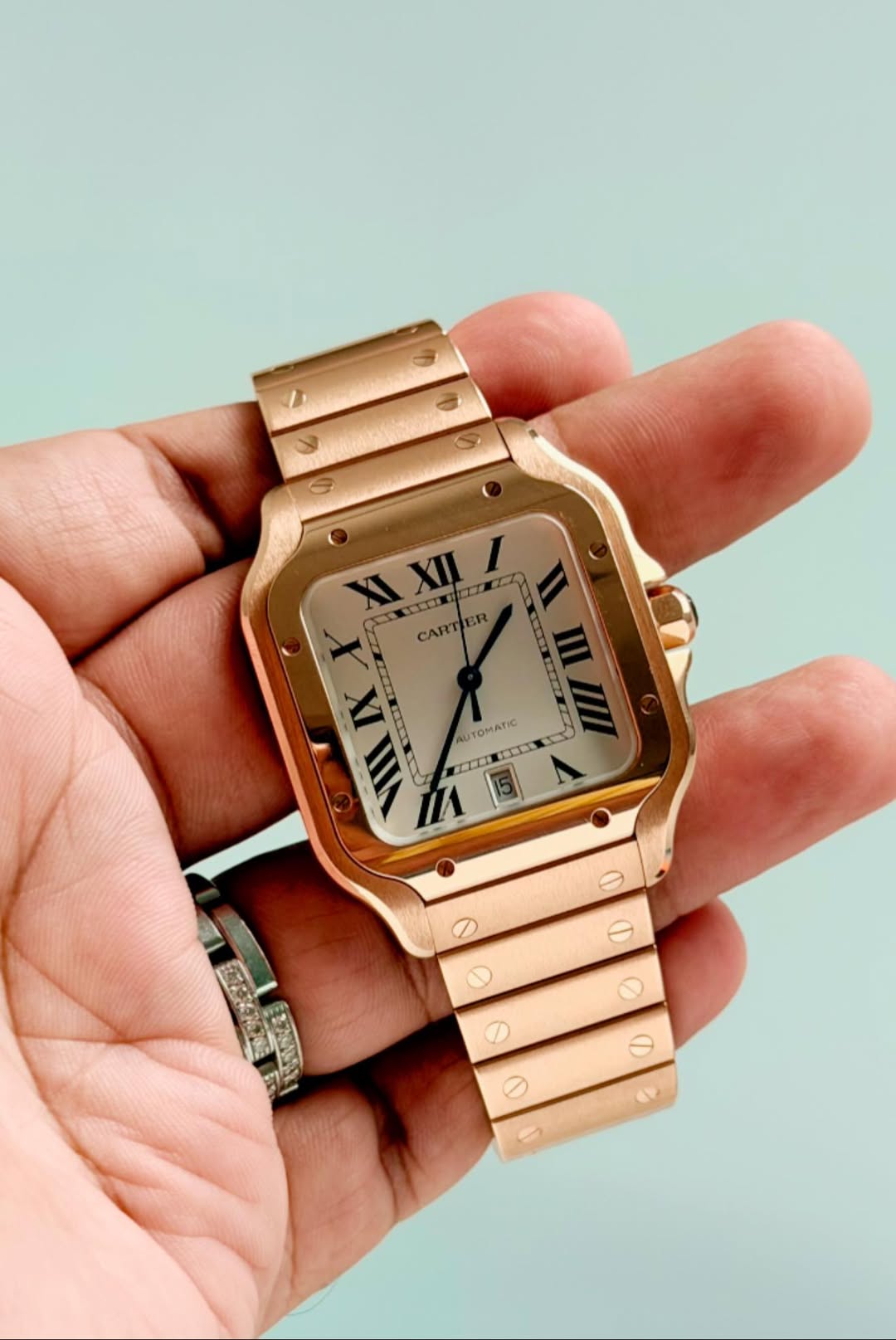 May be an image of digital watch and text that says 'XI CIIE XII I X CARTIER XIXII/ ER CART IX VIII NIIX ا AUT TOMATIC OMARI H 1 e'