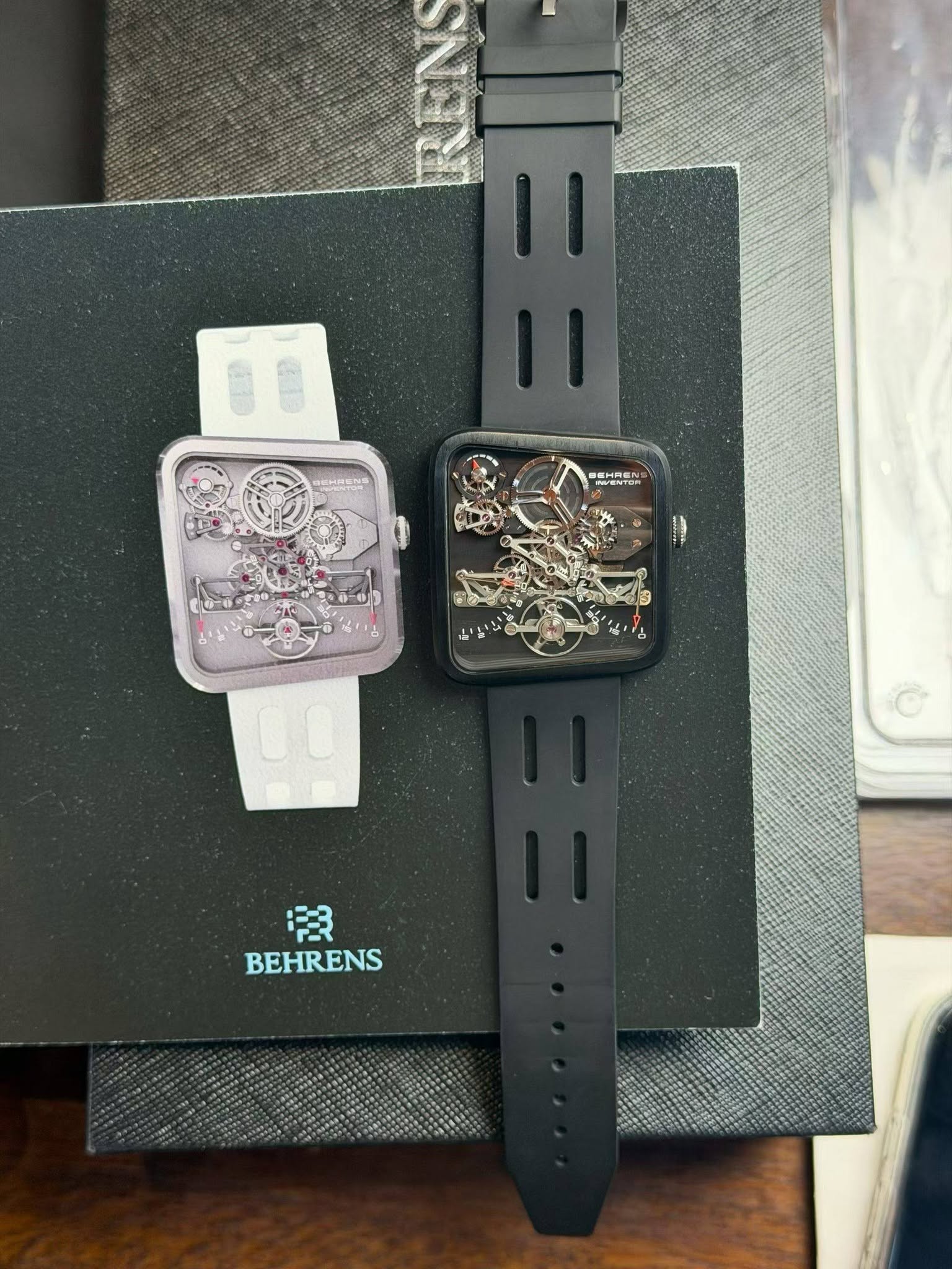 May be an image of phone, digital watch and text that says 'FER BEHRENS'