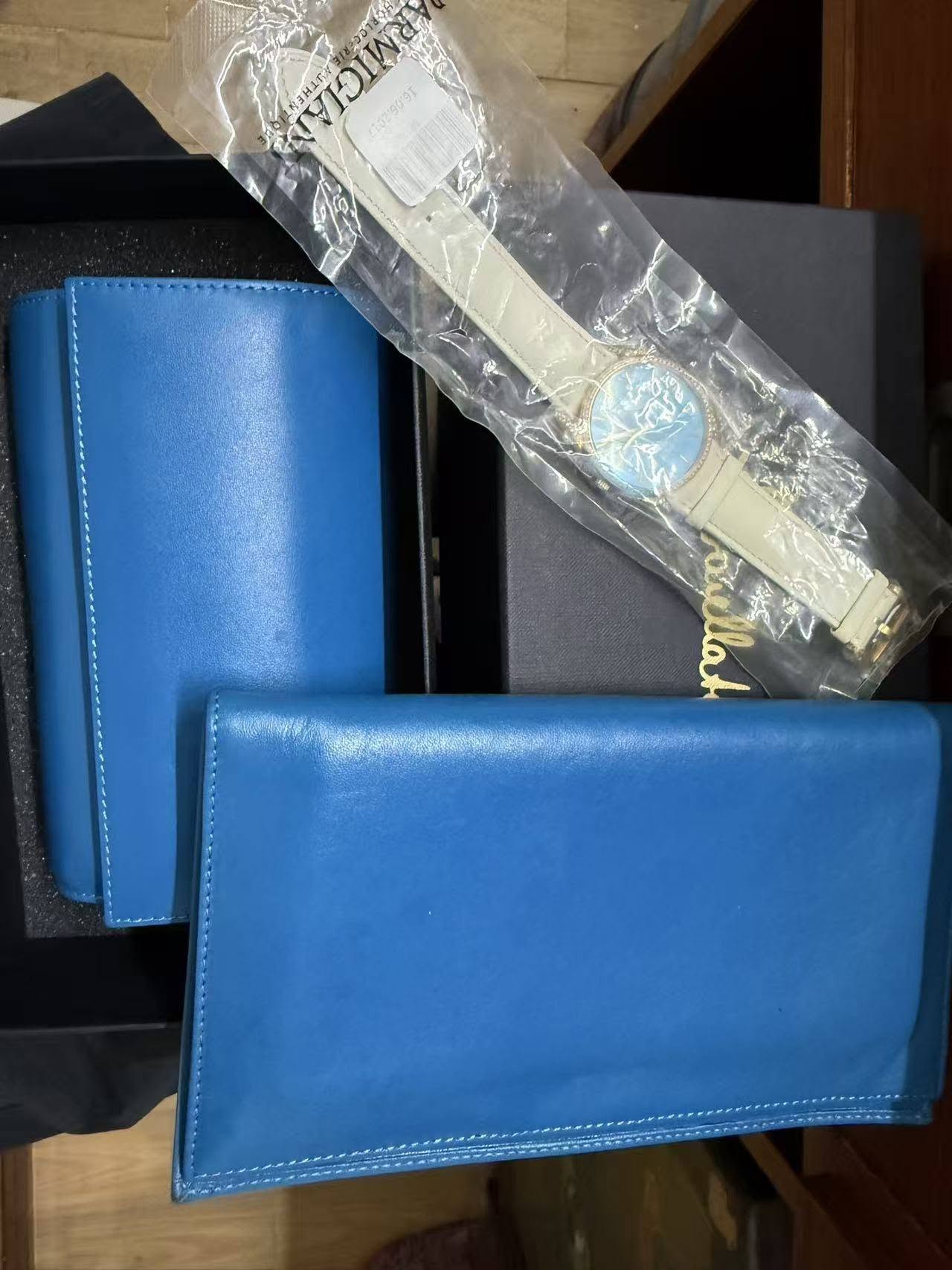 May be an image of leather wallet, leather and saddle-stitched leather