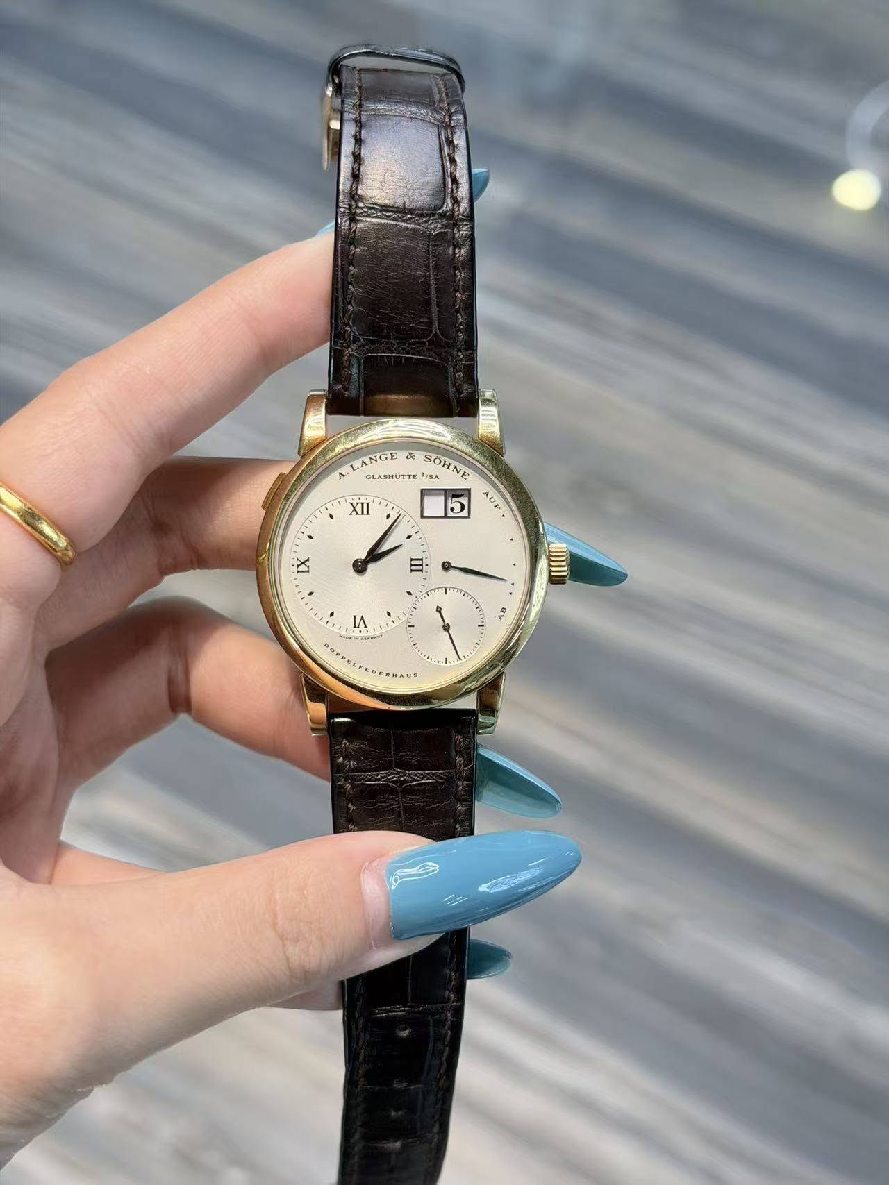 May be an image of jewelry, wrist watch and text
