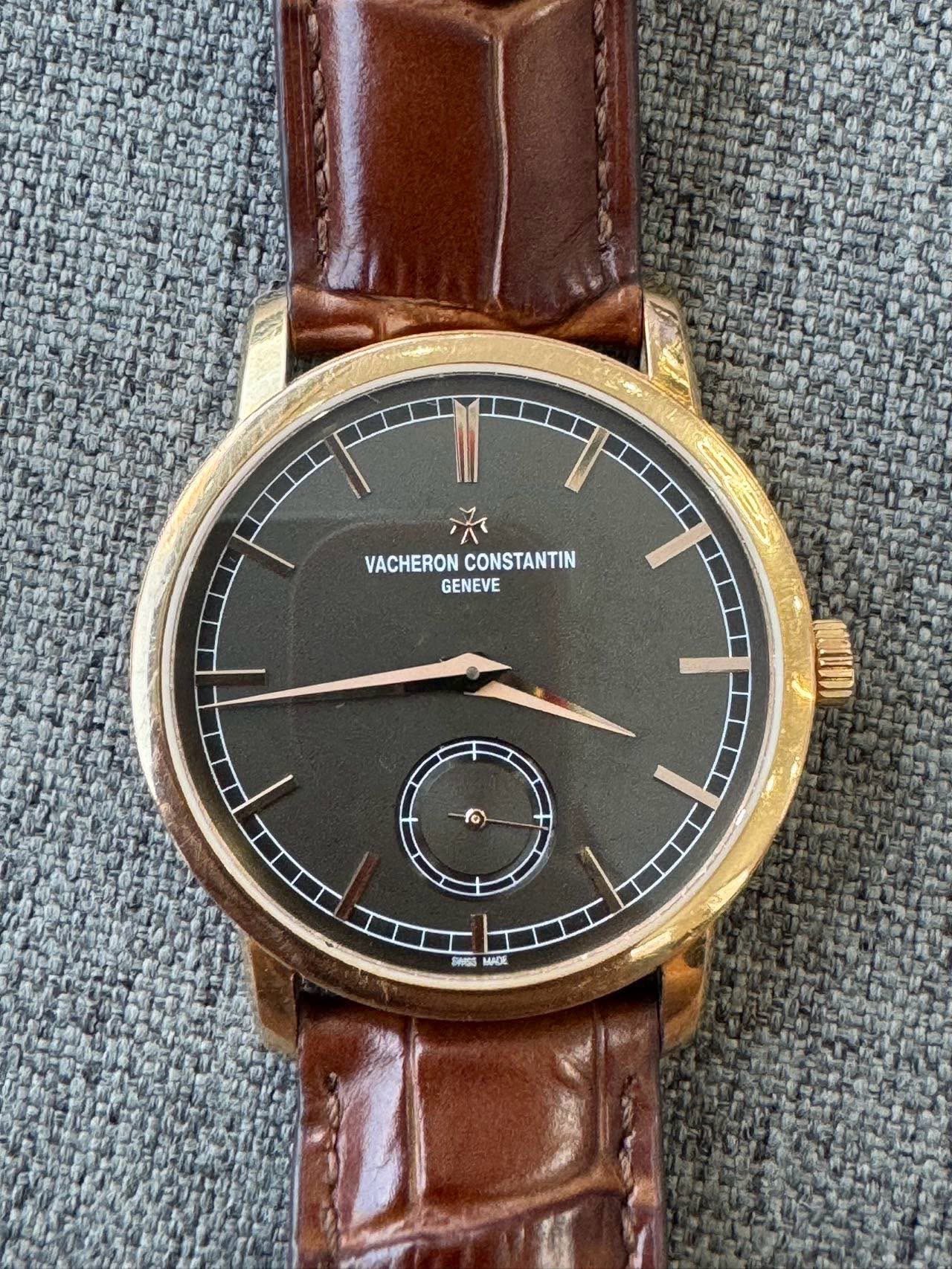 May be an image of leather, wrist watch and text that says 'VACHERON VACHERONCONSTANTIN CONSTANTIN GENEVE 0 អកធ MADE'
