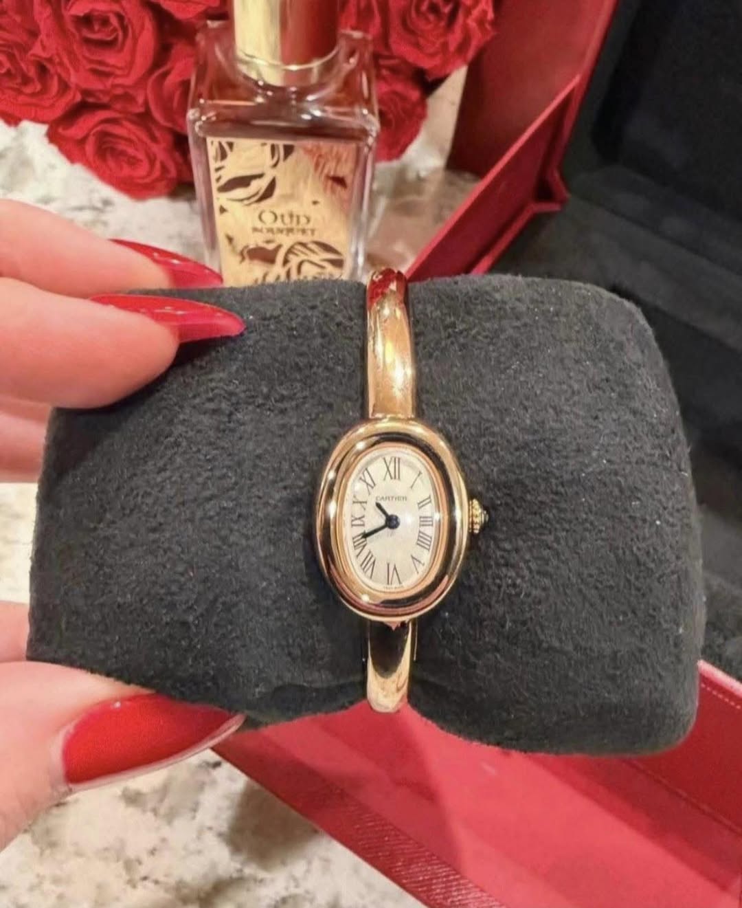 May be an image of fragrance, wrist watch and text