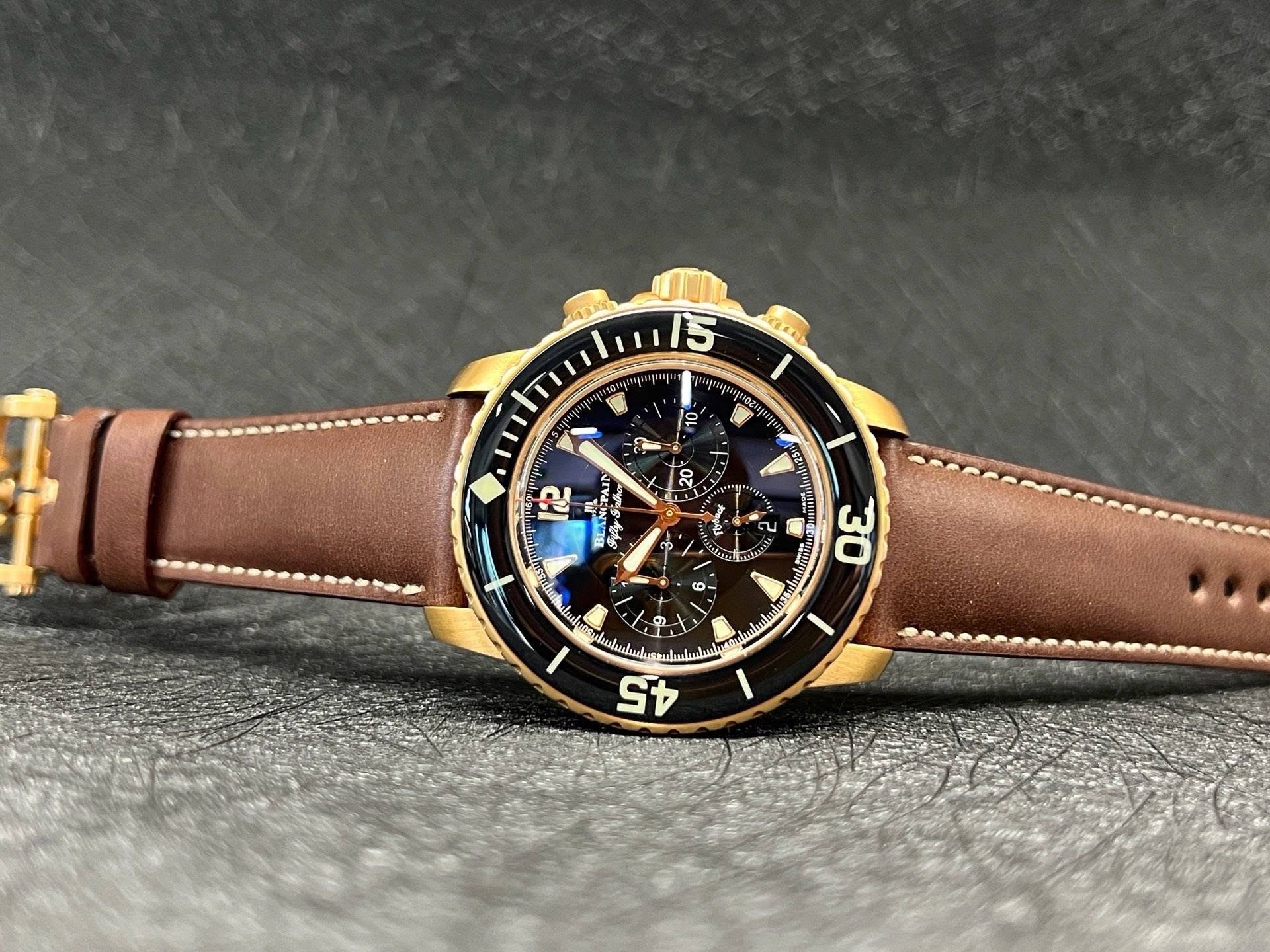 May be an image of leather, wrist watch and text