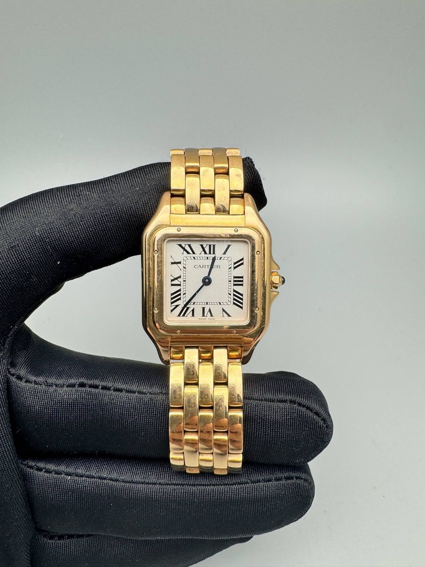 May be an image of wrist watch and text that says '0 XII T 2 e CART R IX EL III II III/I IA'