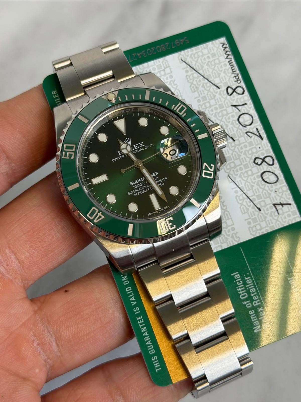 May be an image of wrist watch and text that says 'dd/mm/yyyy 8 10 EX U 50 OYSTER OYSTER ER SUBMA 1000fL NPAGEICIAS 20 4 DE 55 ON VALID IS GUARANTEE THIS Official of Retailer Name…