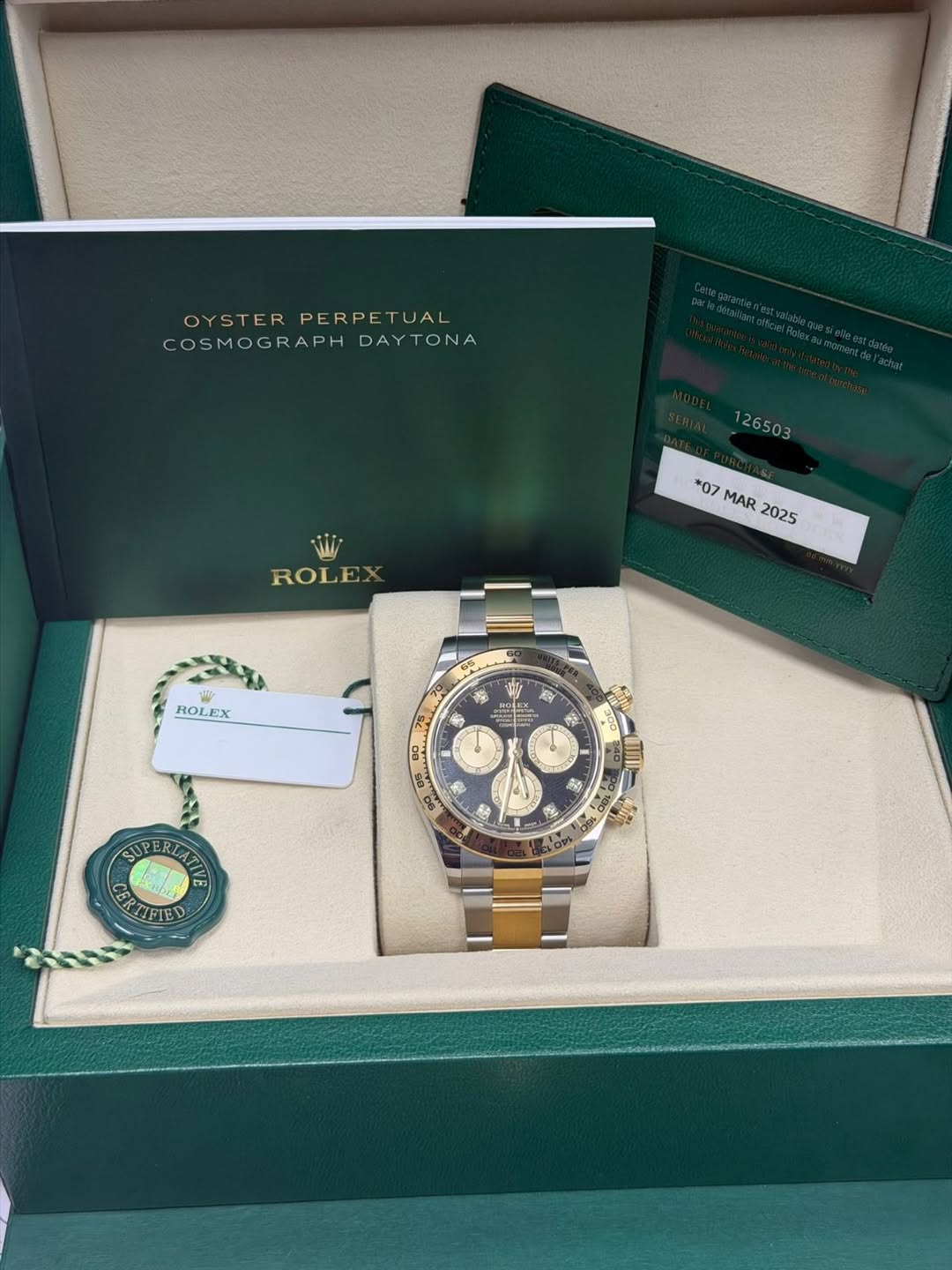 May be an image of wrist watch and text that says 'OYSTER PERPE PERPETUAL TUAL COSMOGRAPHDAYTONA DAYTONA 126503 ROLEX *07 MAR 2025 ROLEX 1p D0 ラ 形 SUPERIATEA GREFIED TIFIED'