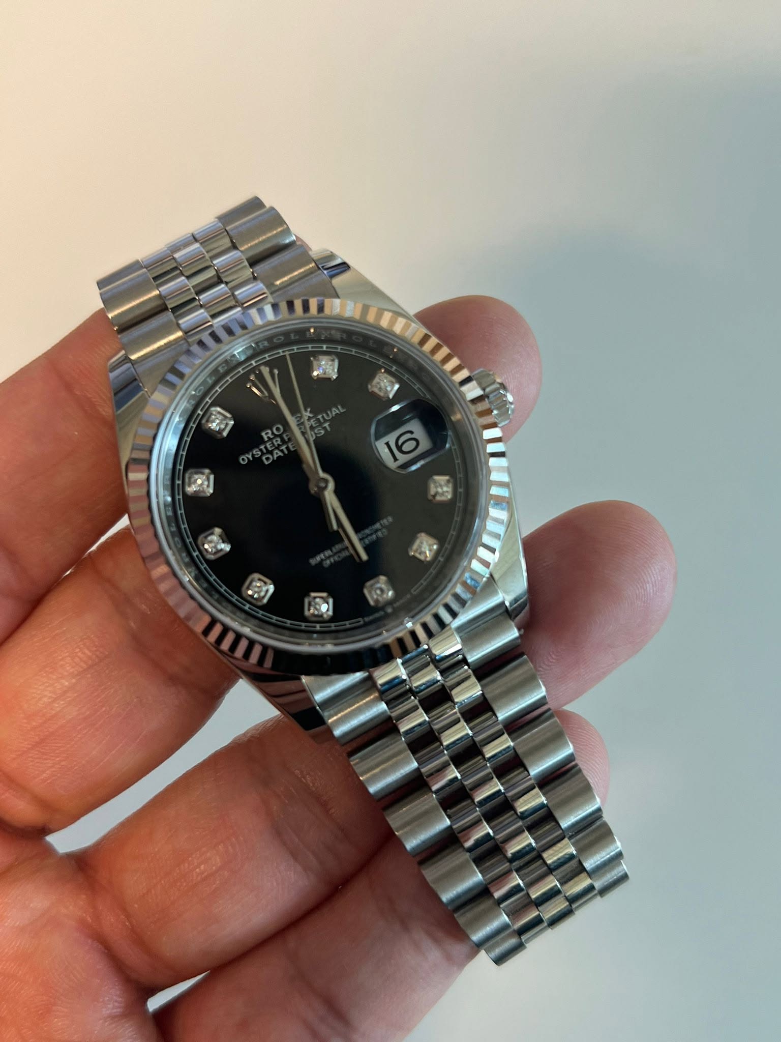 May be an image of wrist watch and text