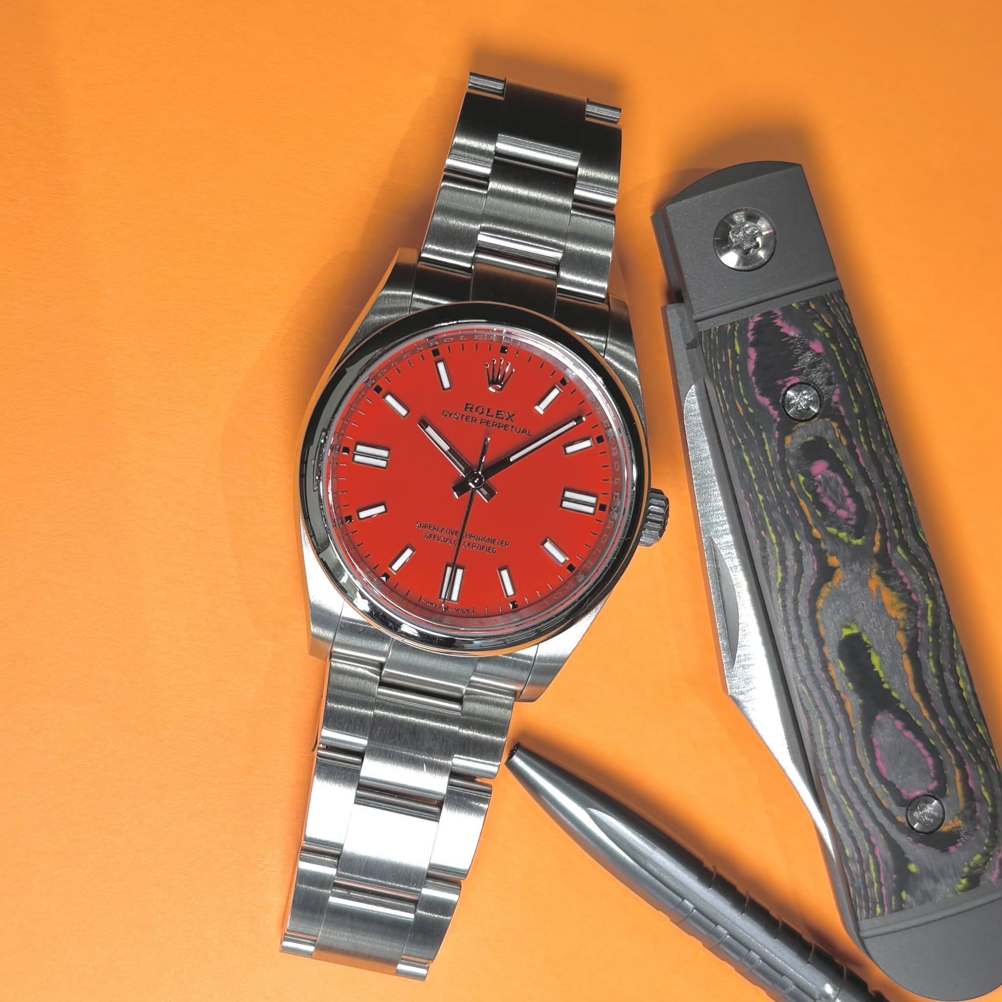 May be an image of knife, wrist watch and text