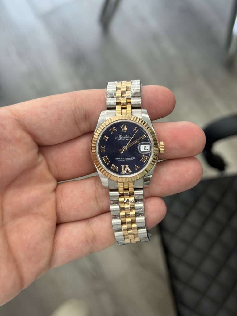May be an image of wrist watch and text